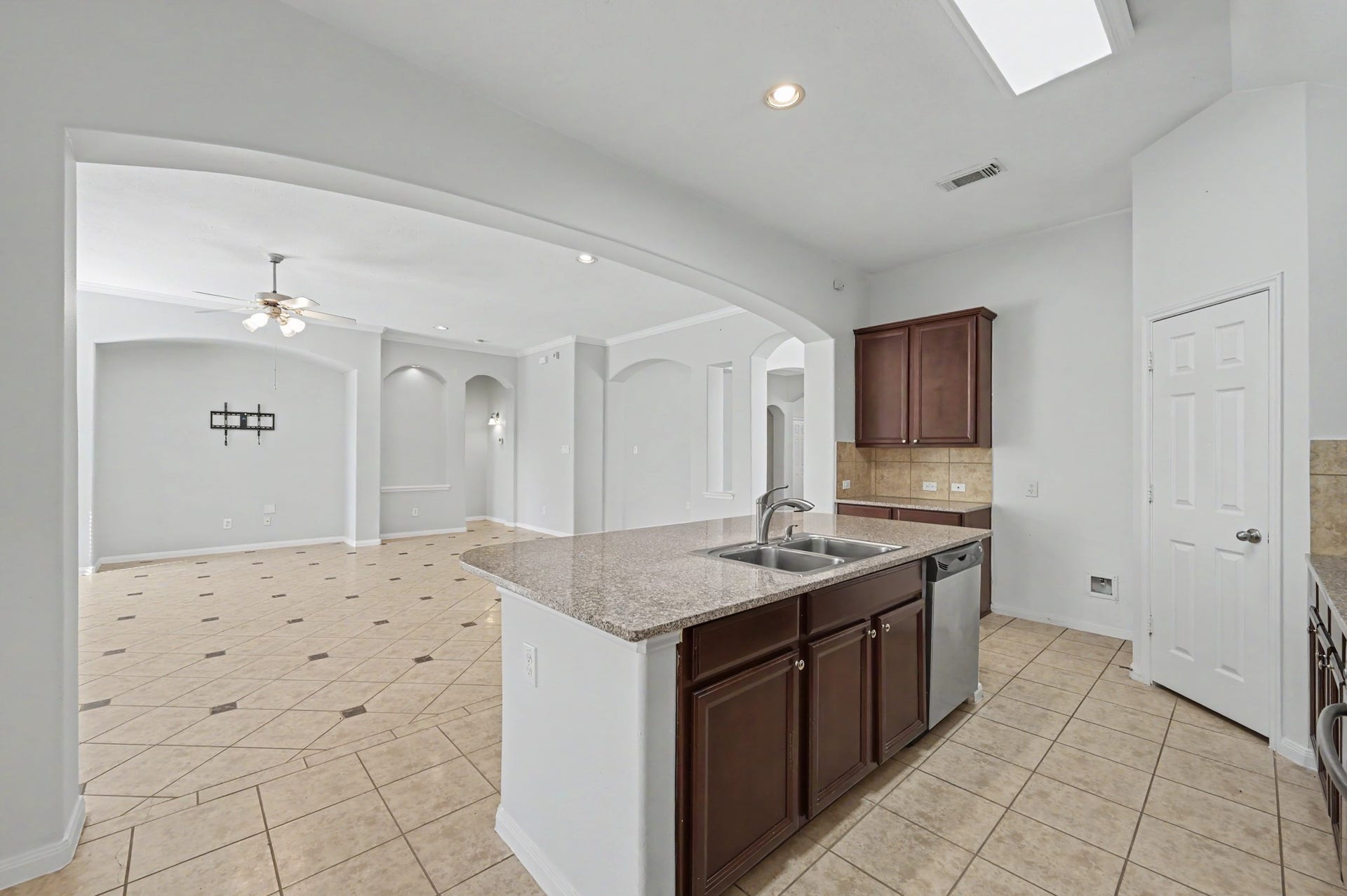 Open-concept island kitchen seamless flow into the spacious family room.