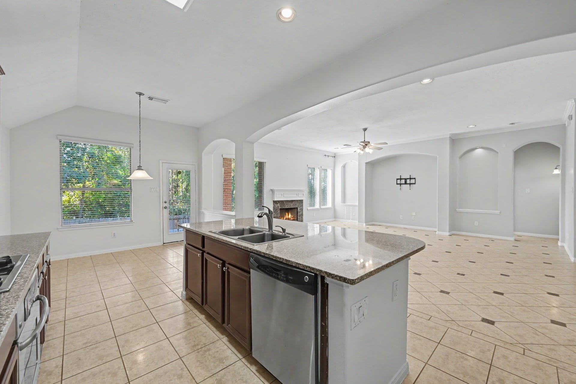 Open-concept island kitchen seamless flow into the breakfast room.