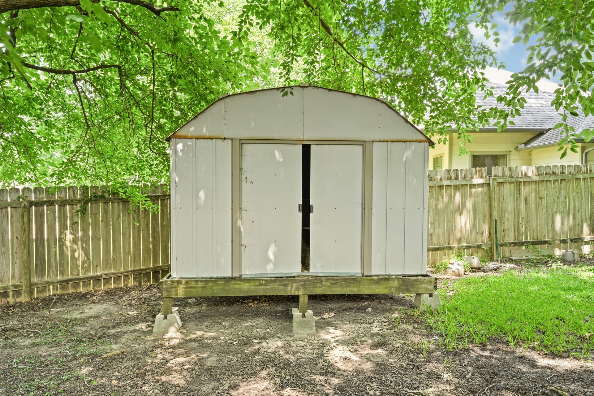107 Harbour Town Lane, Conroe, TX 77356 Convenient standalone storage shed located in the backyard, ideal for lawn equipment and outdoor tools.