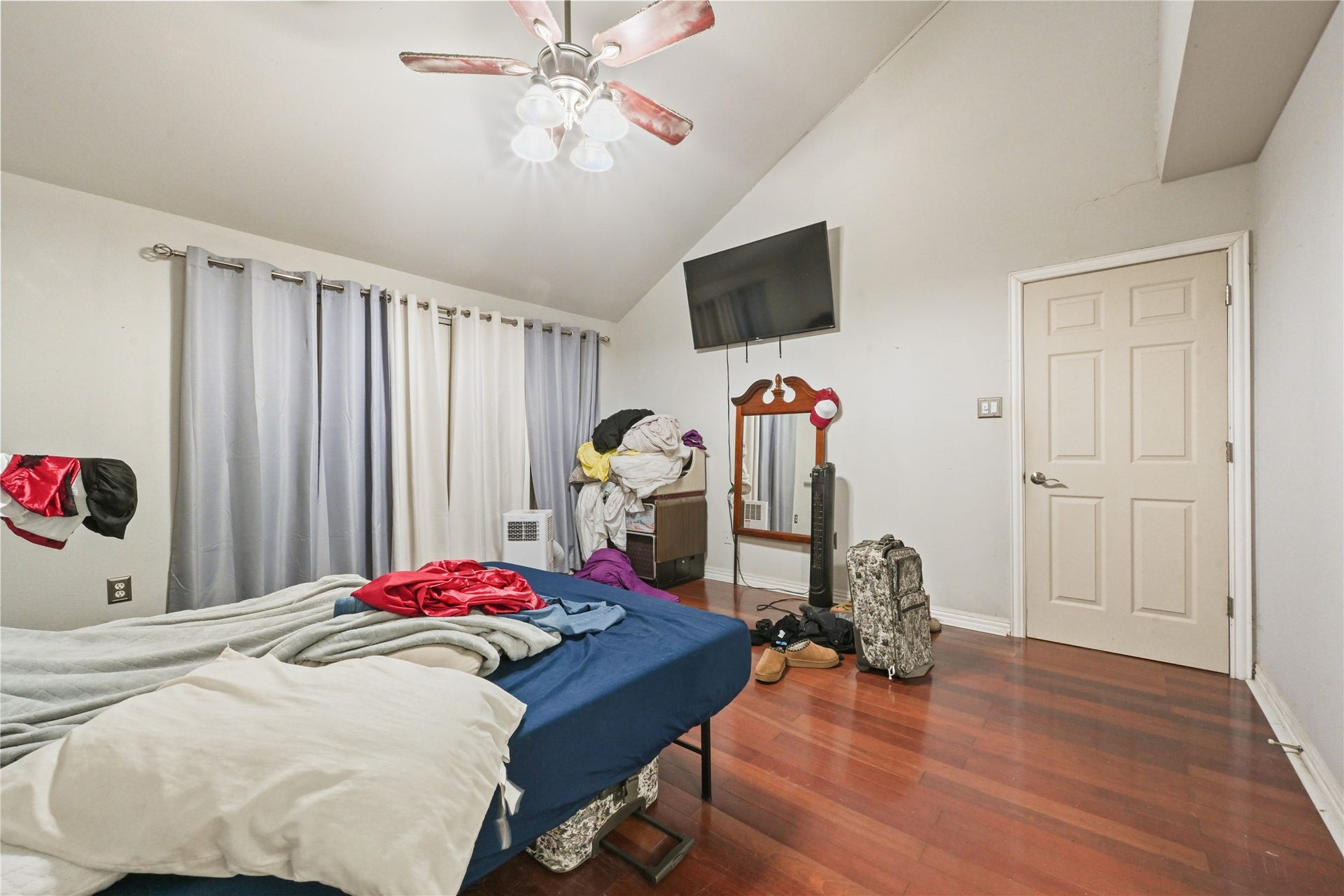 107 Harbour Town Lane, Conroe, TX 77356 Alternate view of the primary bedroom showcasing the rooms layout, natural lighting from the large window, and direct access to the en-suite.