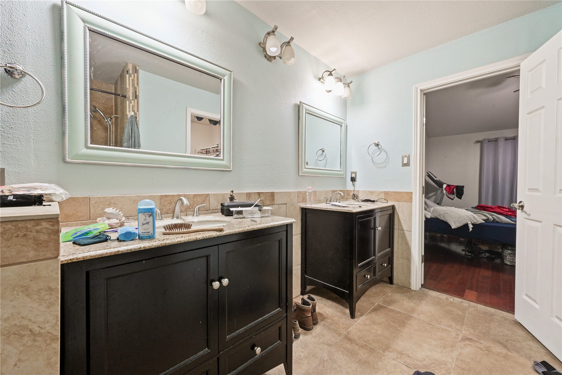 107 Harbour Town Lane, Conroe, TX 77356 Closer view of the primary bathroom layout, highlighting the distinct vanity stations and spacious tiled flooring.