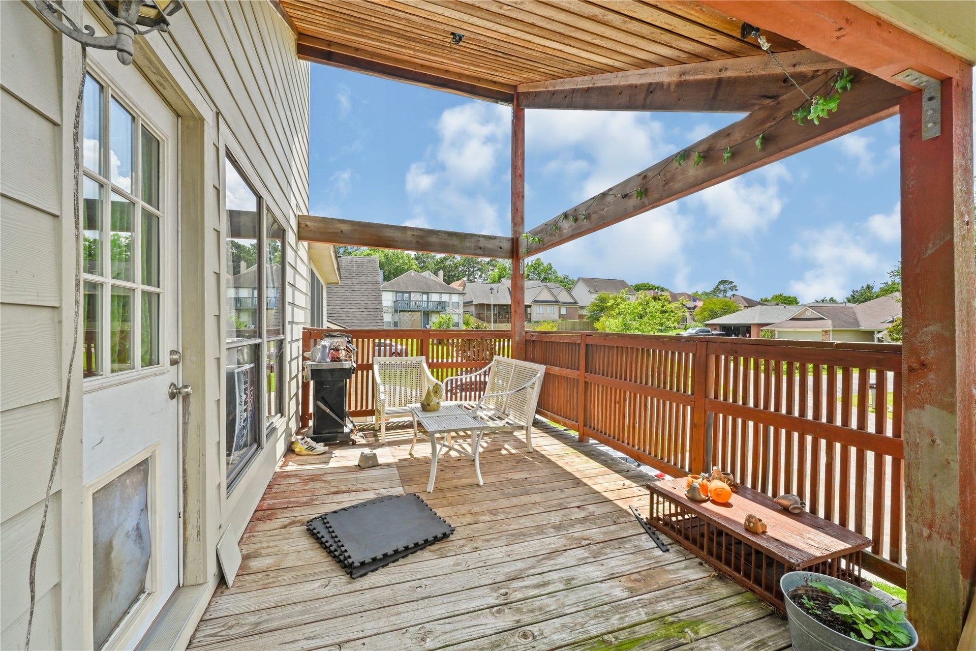 107 Harbour Town Lane, Conroe, TX 77356 Secondary view of the wood deck showing the wraparound railing, open-air layout, and elevated neighborhood views.