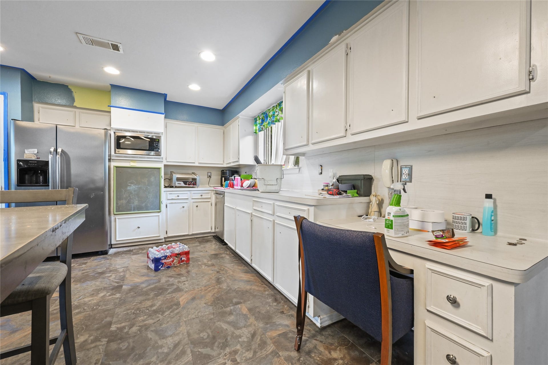 107 Harbour Town Lane, Conroe, TX 77356 Opposite angle of the kitchen highlighting the extensive counter space, built-in desk or prep station, and open layout.