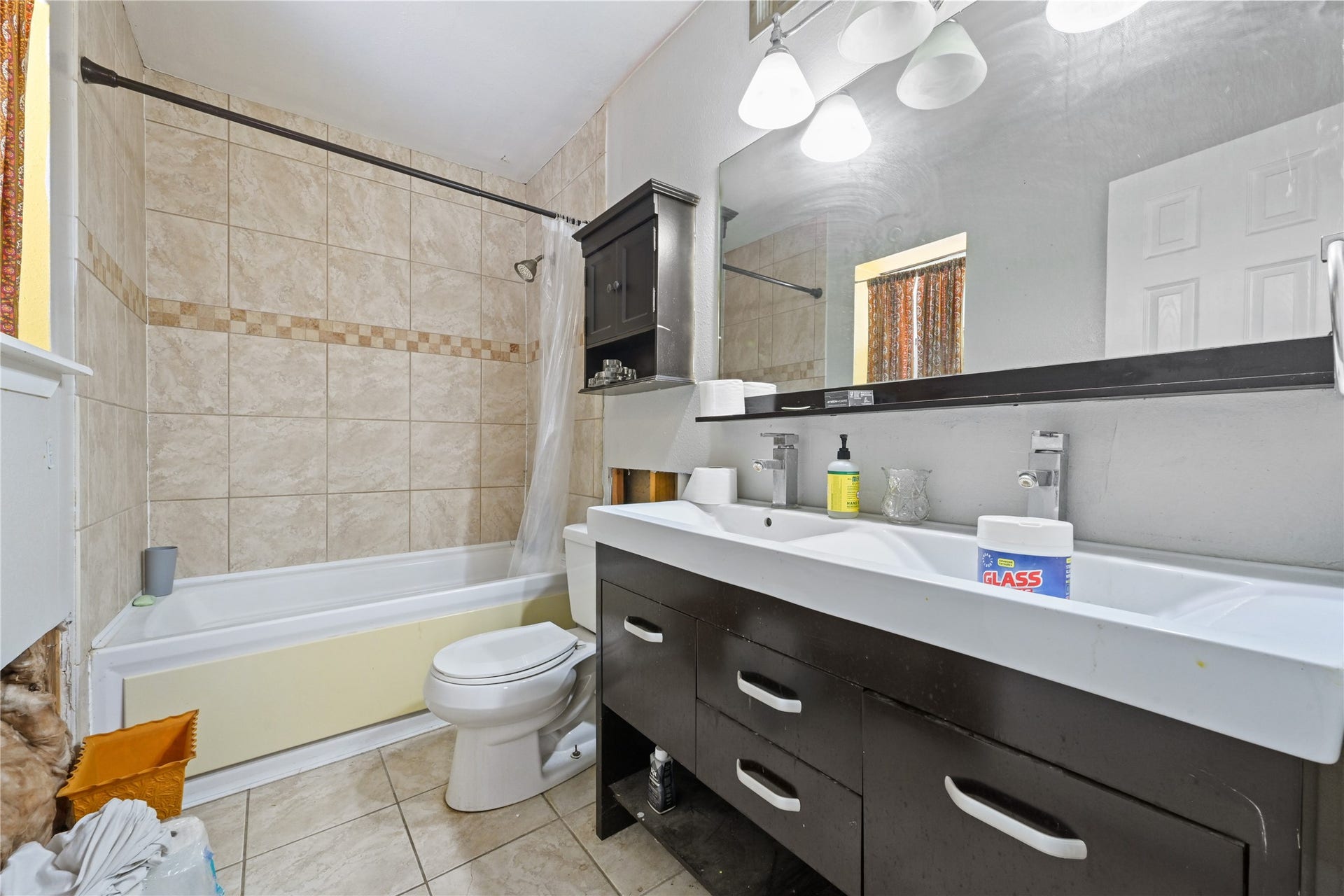 107 Harbour Town Lane, Conroe, TX 77356 Full bathroom featuring an extended dark wood vanity with ample storage, integrated lighting, and a shower/tub combo.