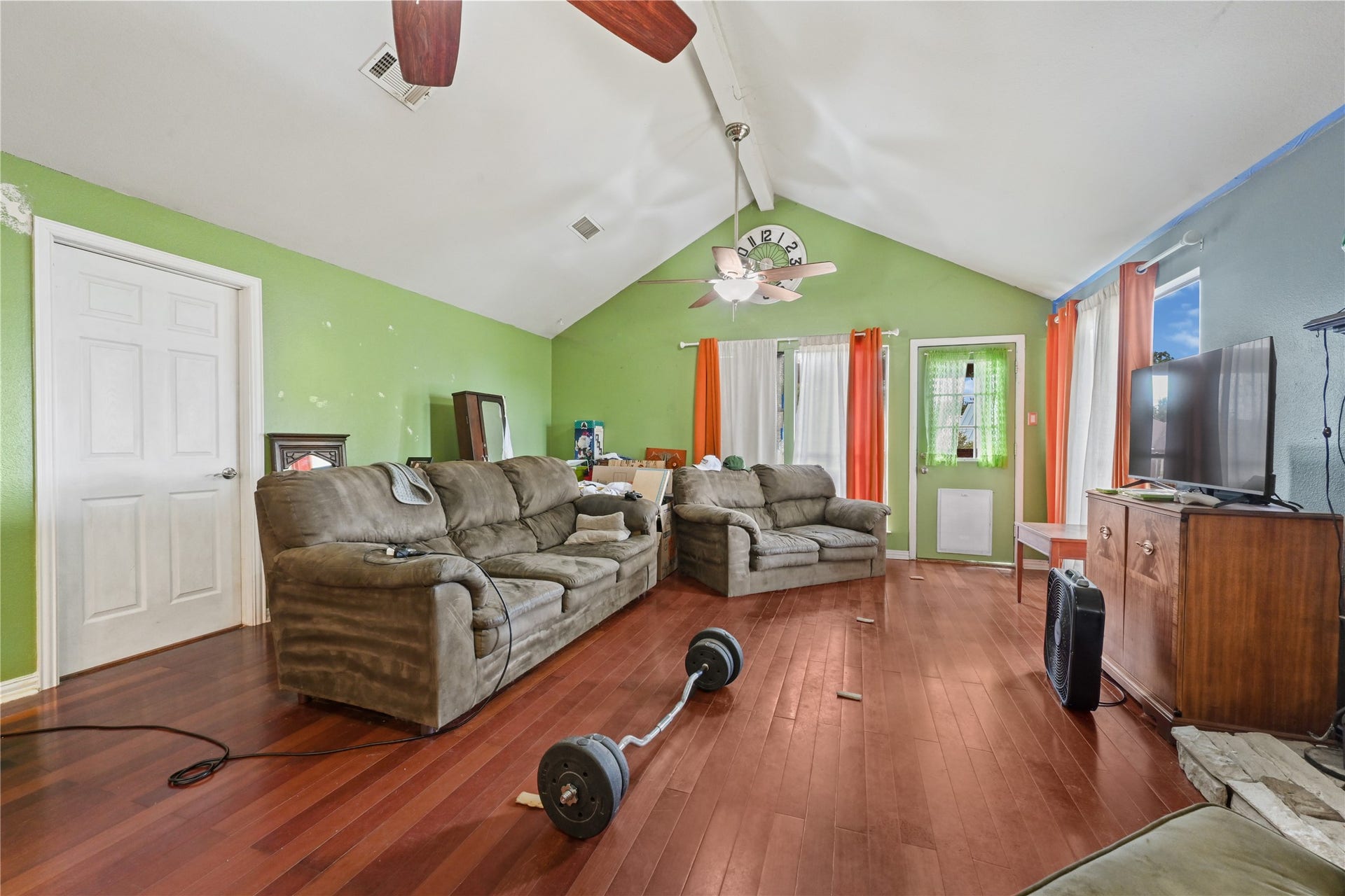 107 Harbour Town Lane, Conroe, TX 77356 Light-filled living room view emphasizing the vaulted ceilings, multiple windows, and seamless connection to the rest of the upper level.