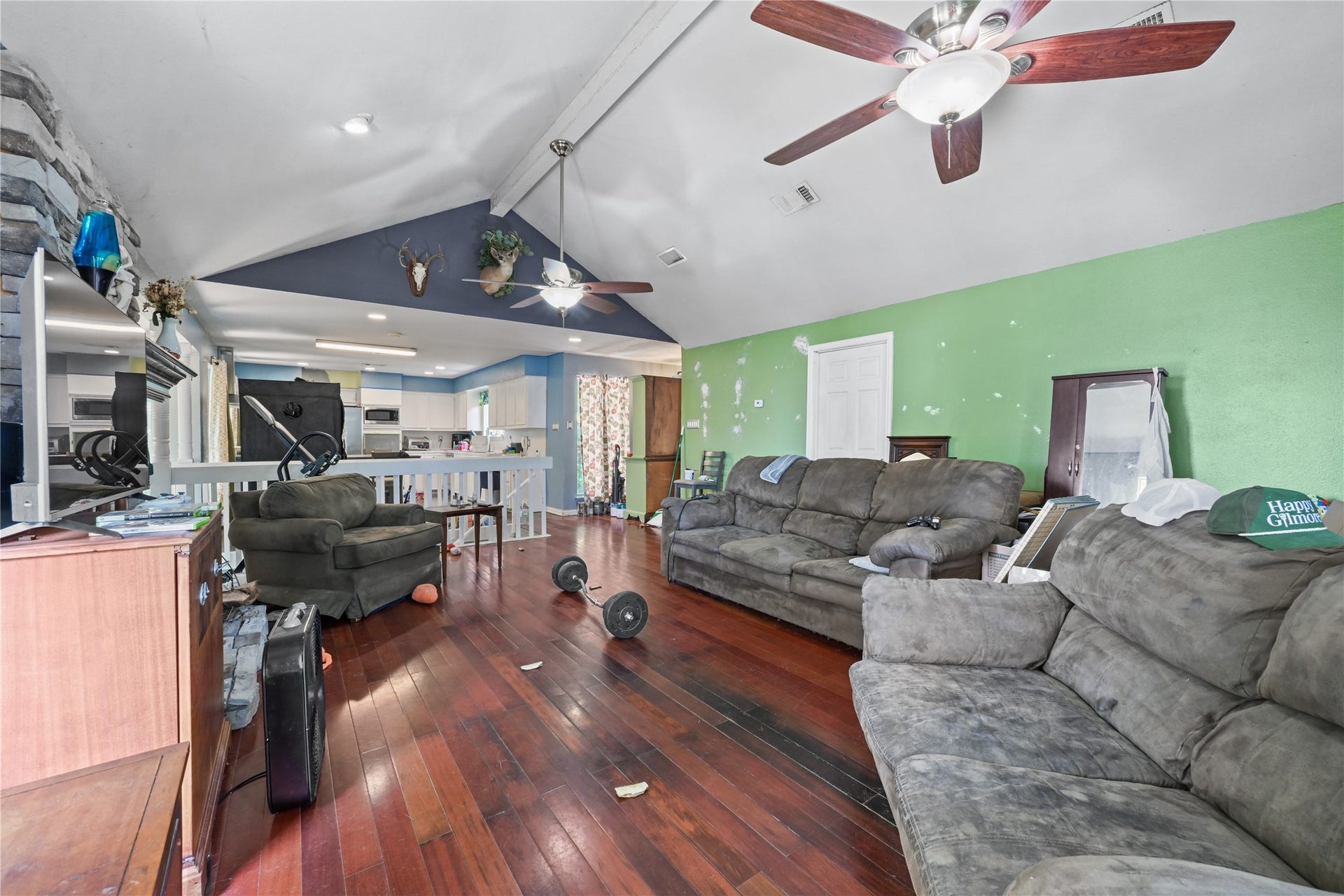 107 Harbour Town Lane, Conroe, TX 77356 A deeper look into the spacious living area, showcasing its versatility for large furniture arrangements and a vibrant accent wall.