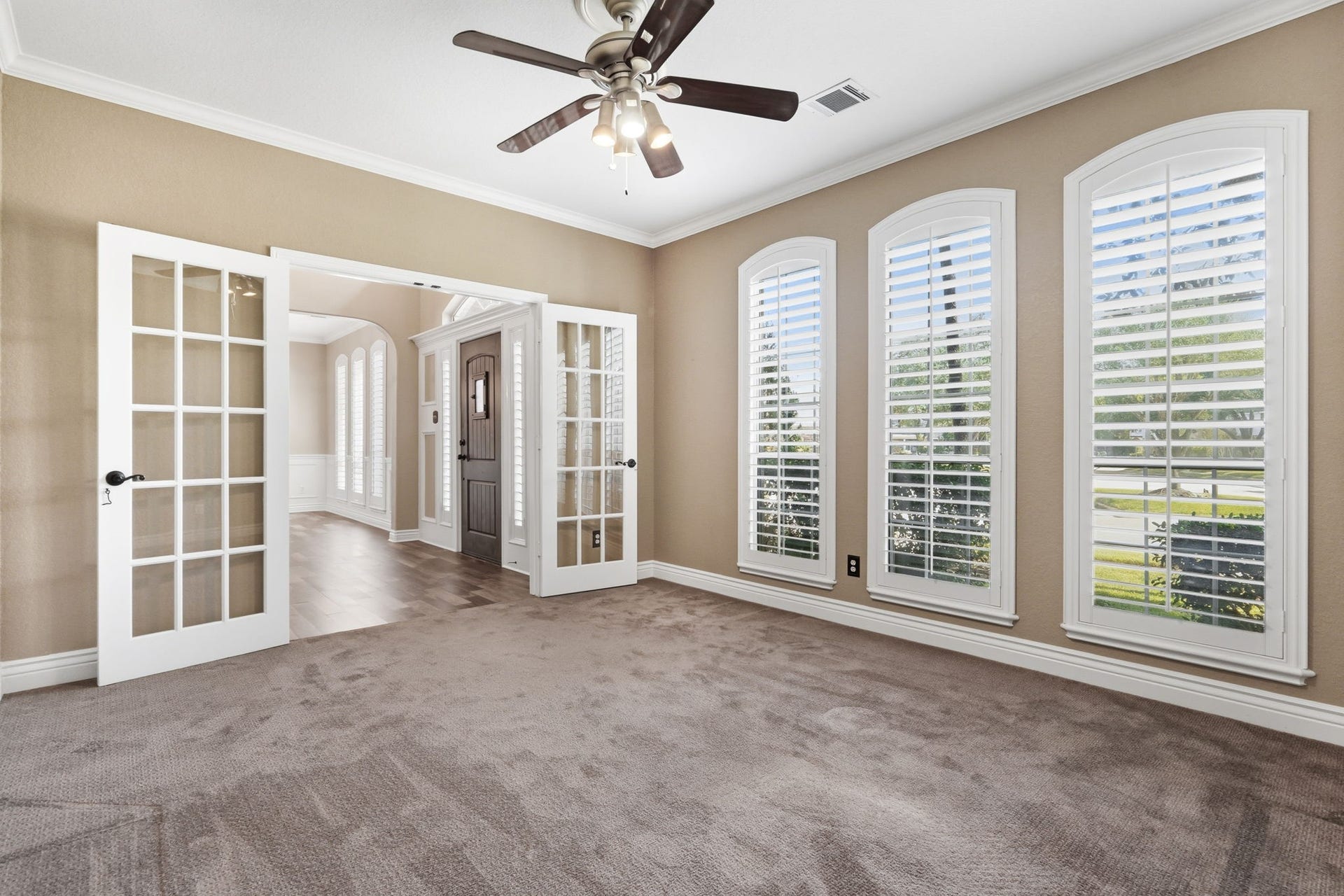 20210 Prim Pine Court, Cypress, TX 77433 Office with French doors and custom shutters, offering a private workspace.