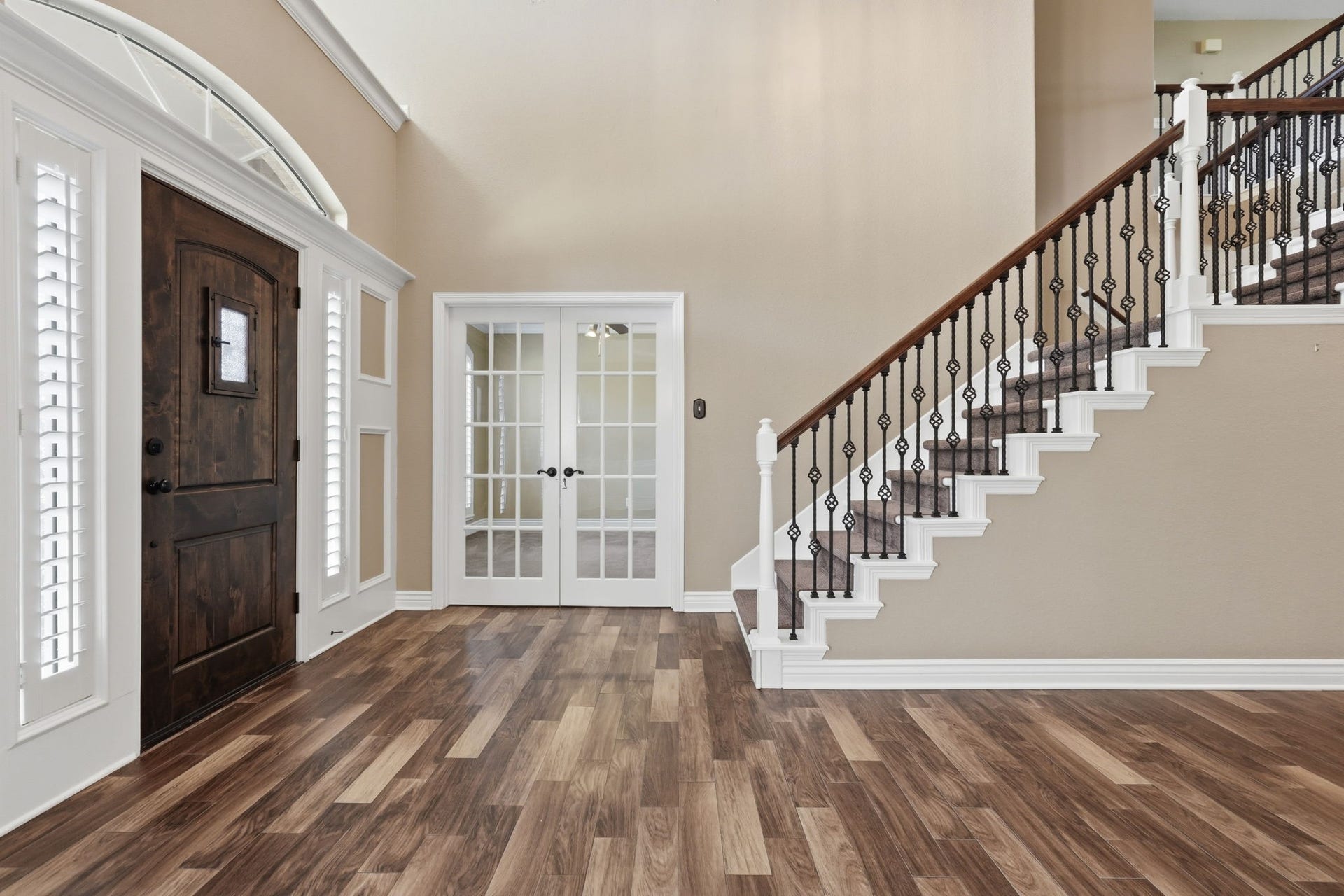 20210 Prim Pine Court, Cypress, TX 77433 A welcoming entryway featuring an elegant wrought iron staircase.
