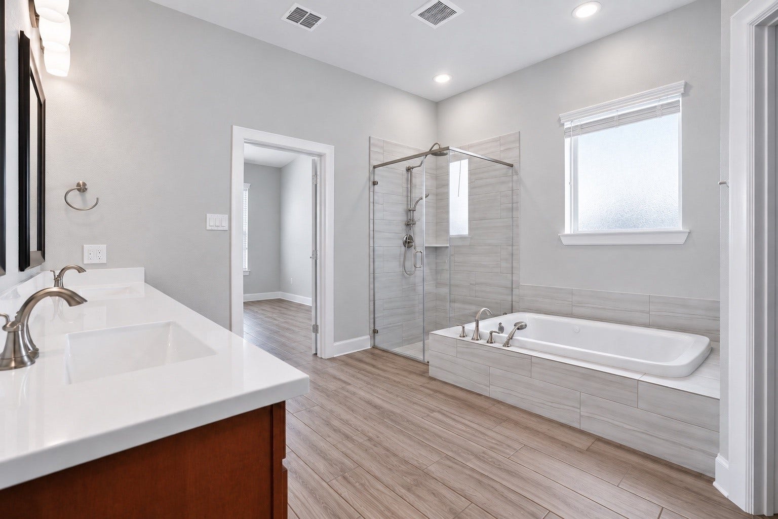 1515 Shining Willow Court, Richmond, TX 77406 Spacious primary bathroom featuring dual sinks, a separate walk-in shower, and a separate soaking tub.
