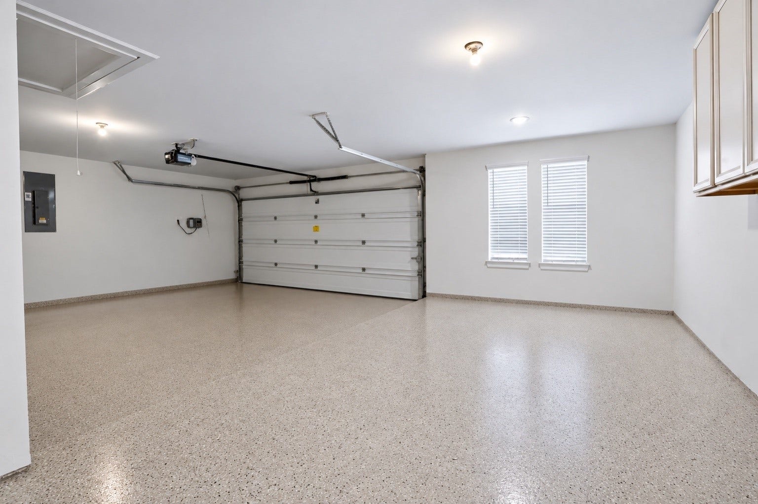 1515 Shining Willow Court, Richmond, TX 77406 Spacious garage with clean epoxy flooring, built-in cabinetry, and plenty of room for parking and storage.