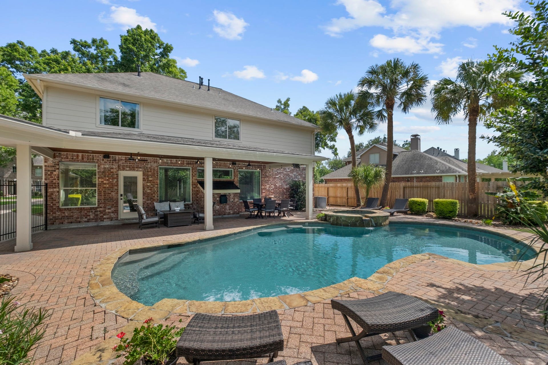 9614 Pennington Lane, Missouri City, TX 77459 Resort style backyard featuring a sparkling pool and attached hot tub.