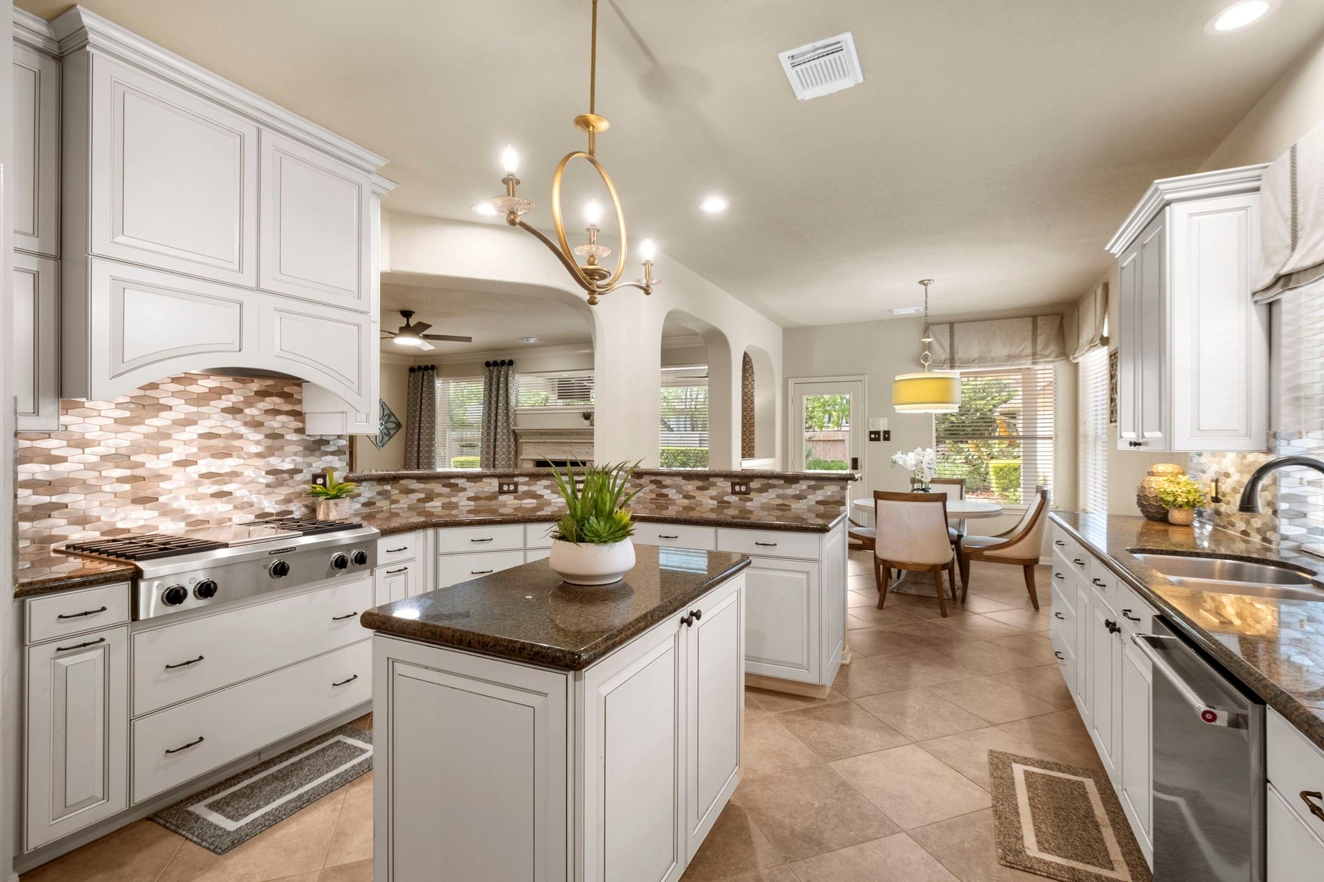 9614 Pennington Lane, Missouri City, TX 77459 Undercabinet lighting enhances both ambiance and functionality. Spacious island provides additional prep space and casual seating.