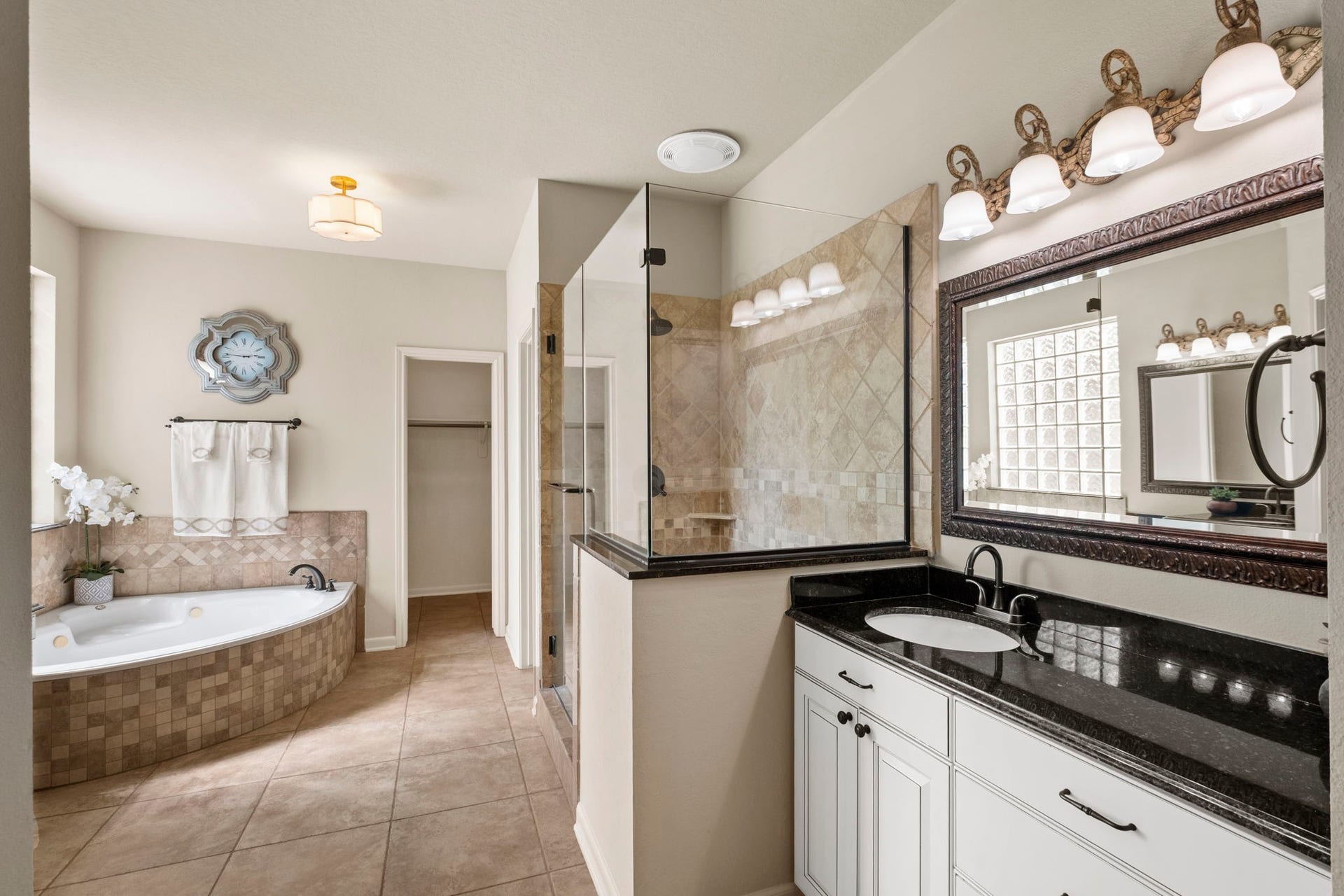 9614 Pennington Lane, Missouri City, TX 77459 Spa inspired primary bathroom features dual vanities and a soaking tub.