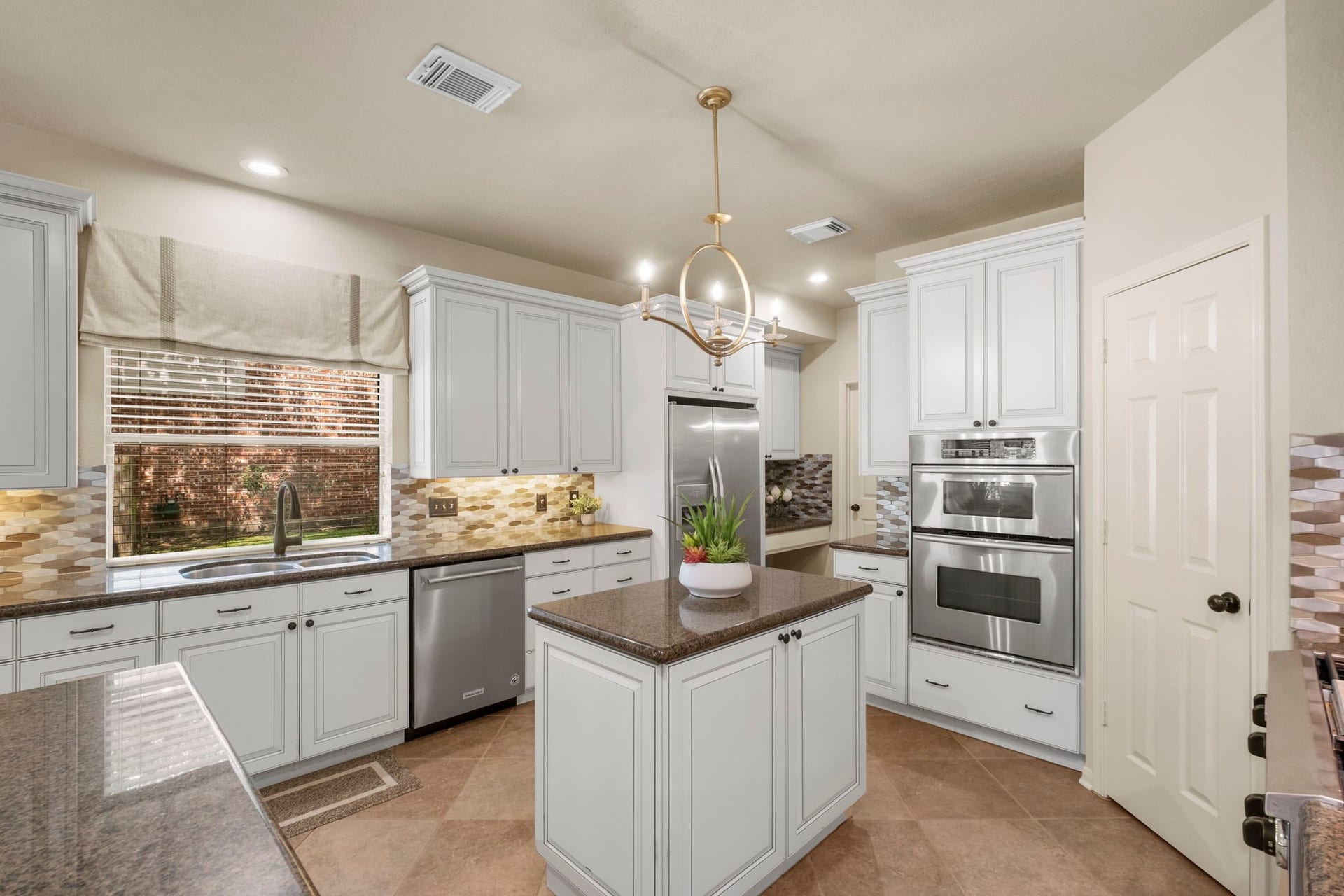9614 Pennington Lane, Missouri City, TX 77459 KitchenAid built in refrigerator adds a luxury touch to the heart of the home.