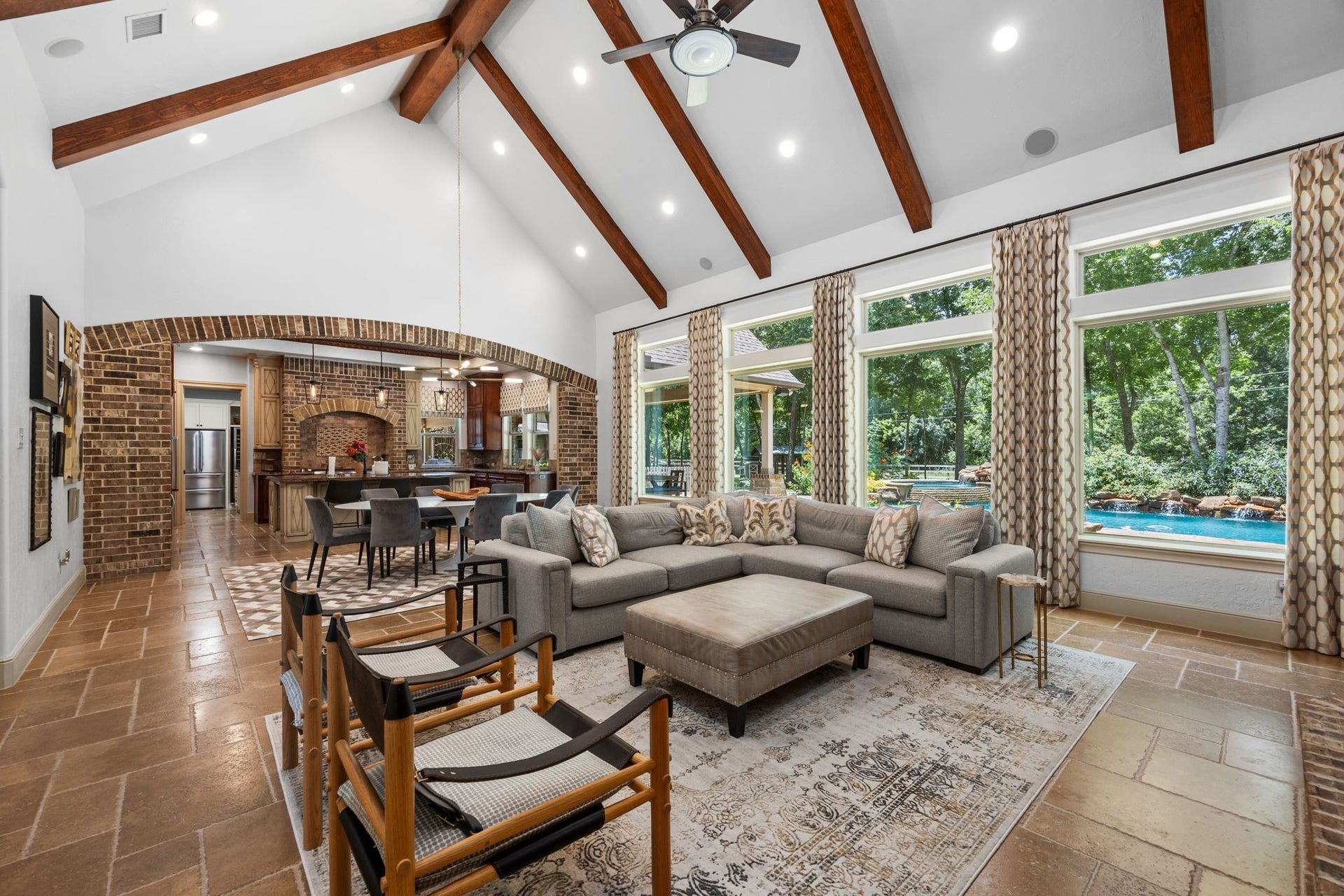 2734 Forest View, Richmond, TX 77406 Living area view into dining and kitchen. Brick work archway accents the kitchen area. Again simply wonderful nature and pool views.