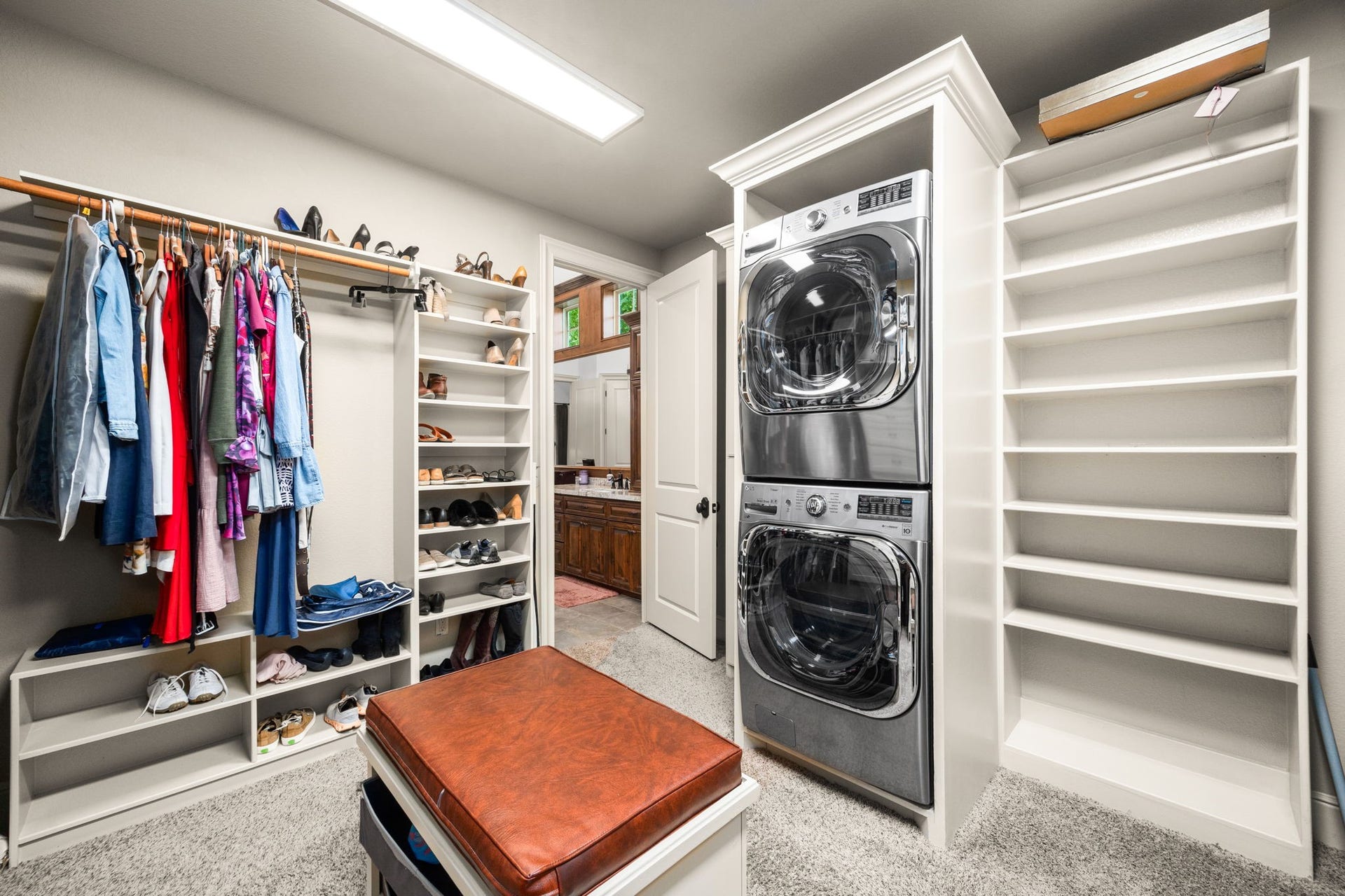 2734 Forest View, Richmond, TX 77406 Primary closet is off the ensuite bath. Washer/dryer for downstairs is tucked away here.