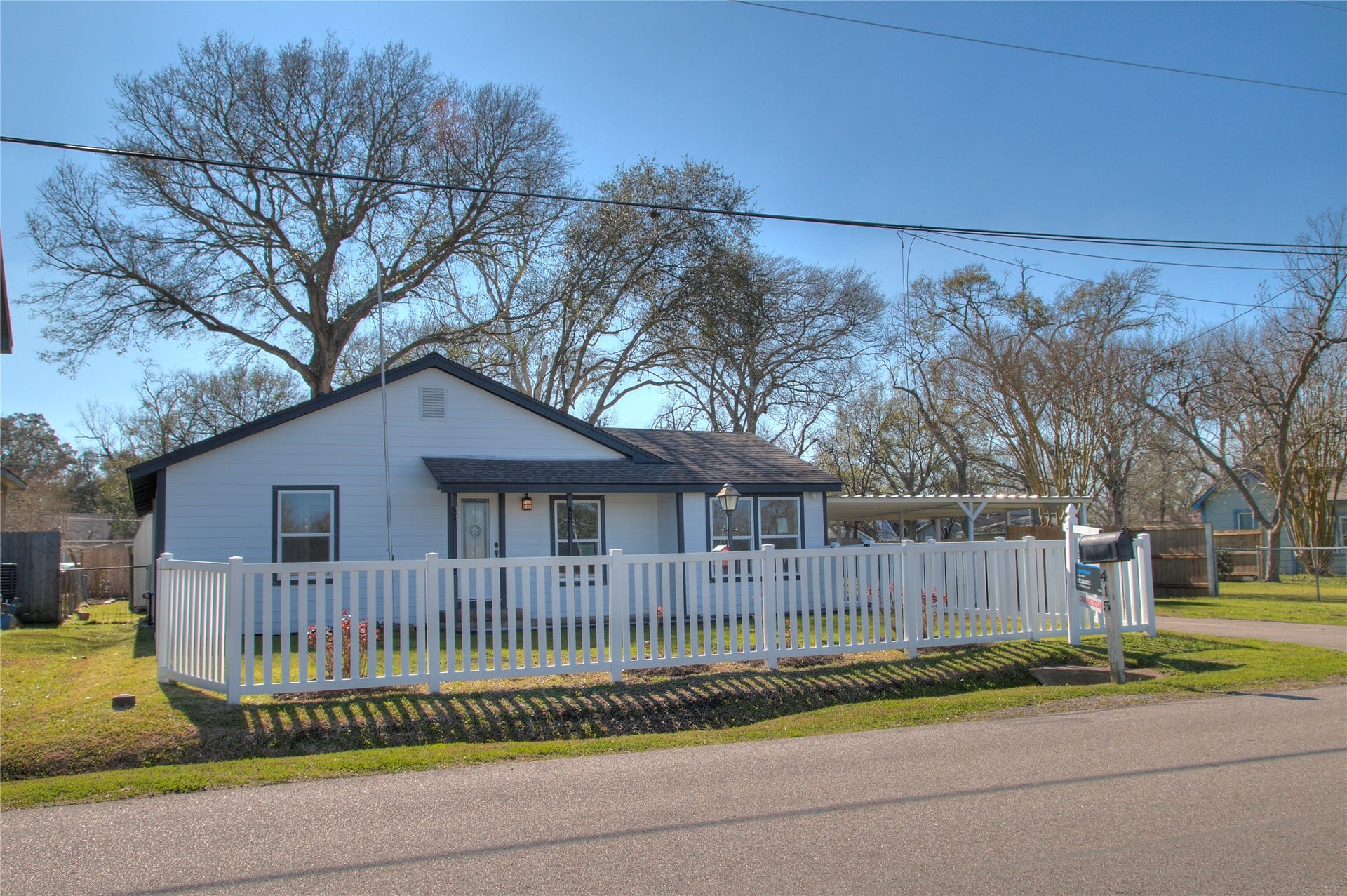 415 Perkins Avenue, League City, TX 77573 Stylishly renovated one-story home with charming white picket fence. Perfect blend of modern comfort and classic appeal.
