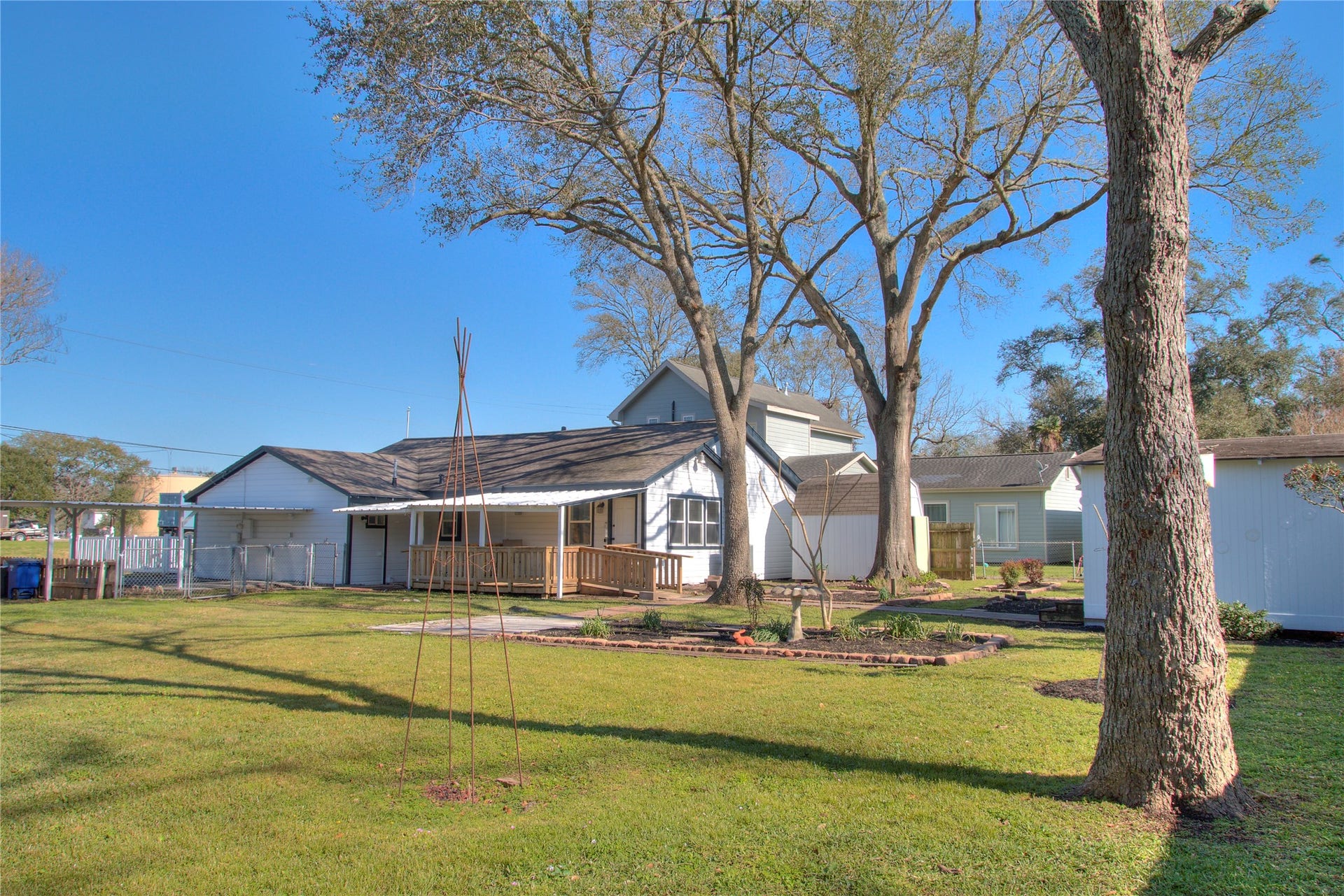 415 Perkins Avenue, League City, TX 77573 Enjoy the serene backyard with mature trees providing ample shade.