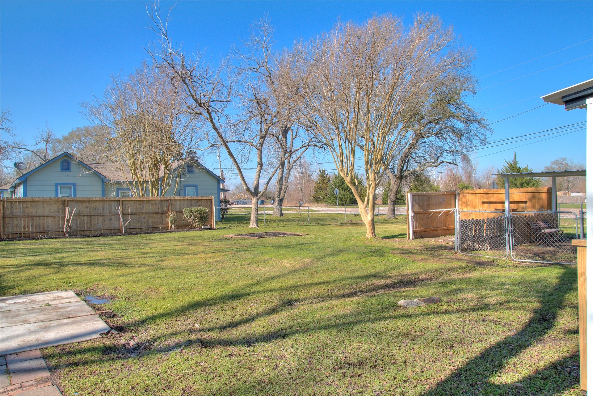 415 Perkins Avenue, League City, TX 77573 Spacious extra lot perfect for RV storage or building a private guest house with a wood fence.