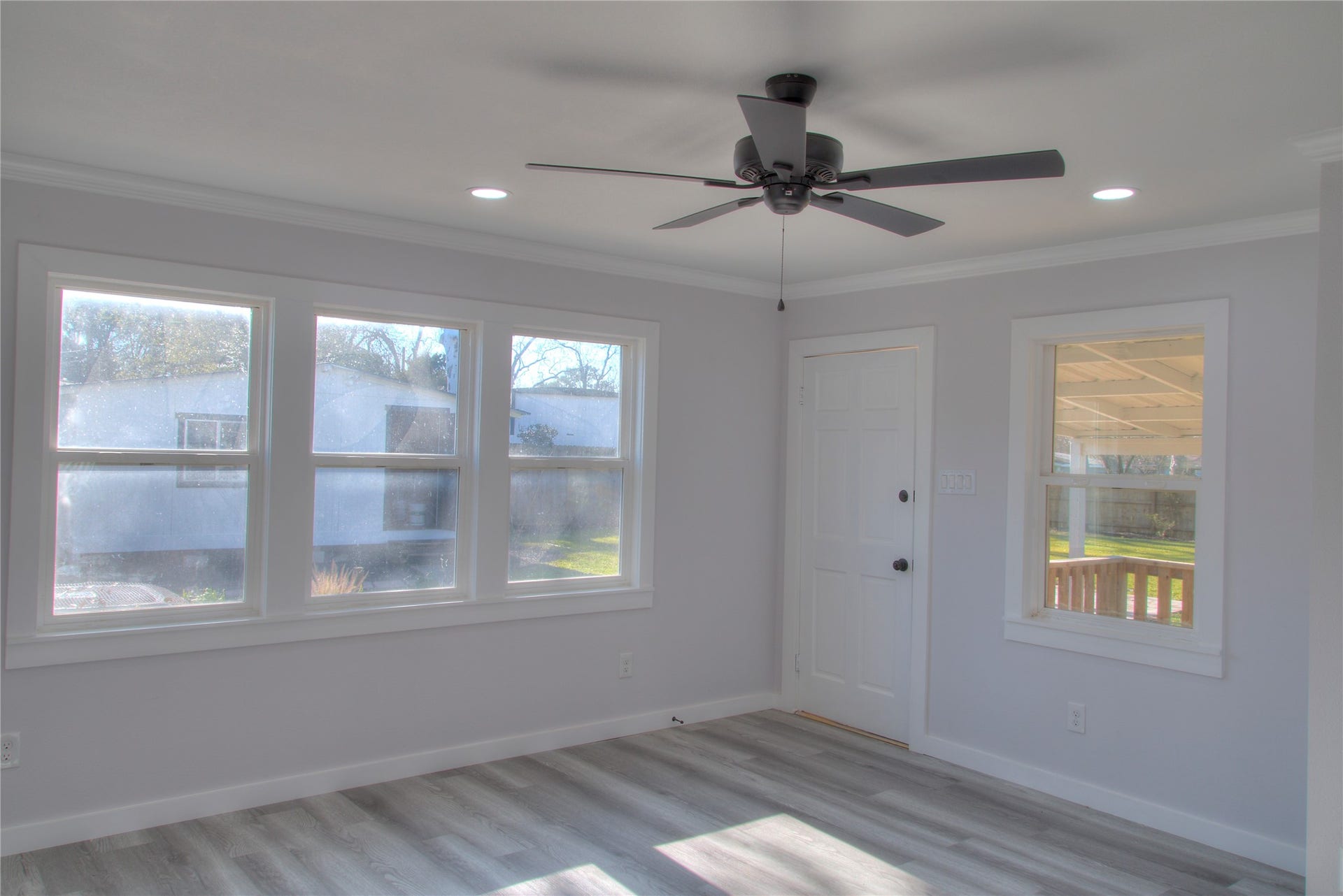 415 Perkins Avenue, League City, TX 77573 Bright dining/family room with a large window offering serene backyard views.
