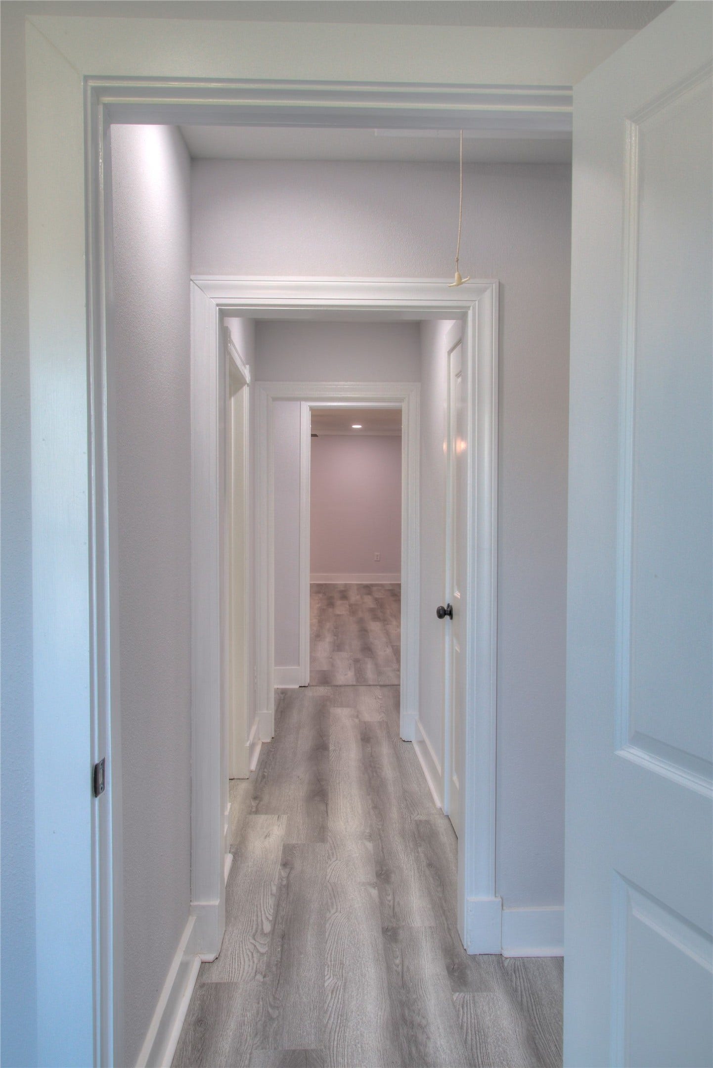 415 Perkins Avenue, League City, TX 77573 A welcoming hallway seamlessly connecting the primary suite with additional bedrooms.