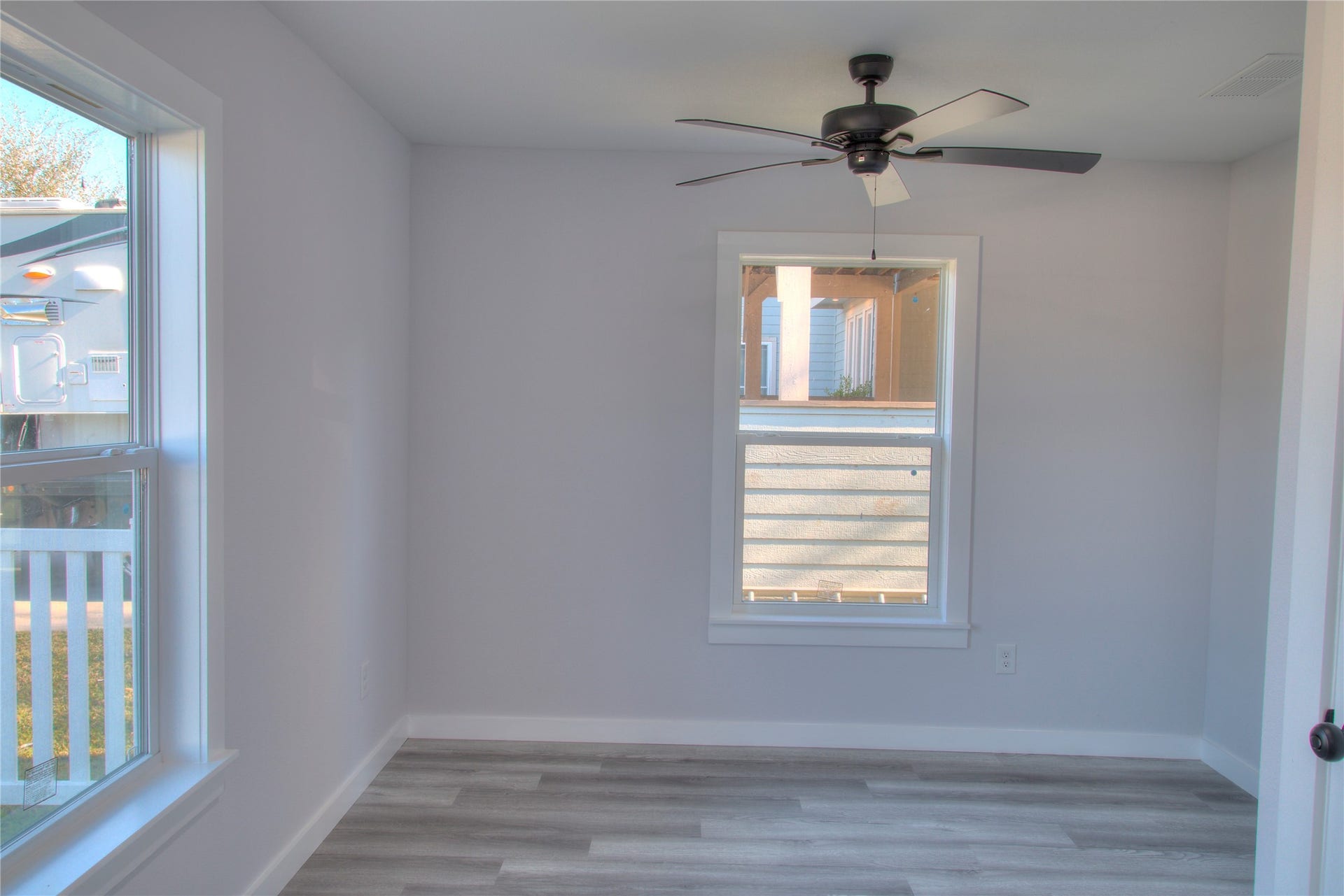 415 Perkins Avenue, League City, TX 77573 Cozy secondary bedroom featuring ample natural light and a sleek ceiling fan. Perfect for guests or a home office.