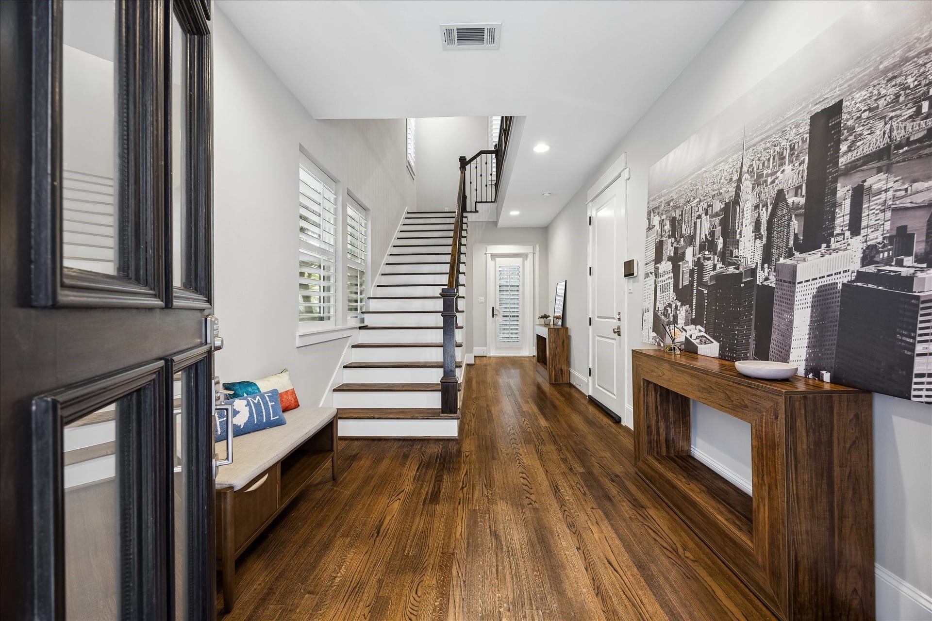 2915 Hicks Street, Houston, TX 77007 A welcoming entryway features rich hardwood floors and a stylish staircase with plantation shutters creating a sophisticated first impression.