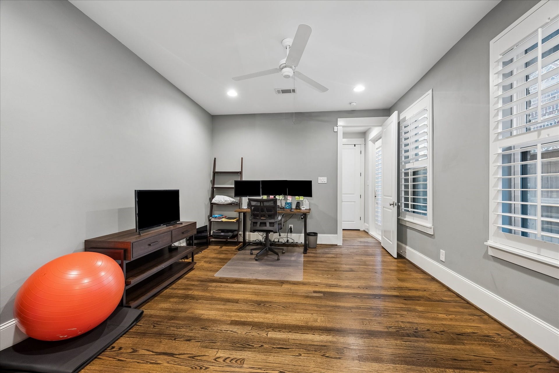 2915 Hicks Street, Houston, TX 77007 Inviting office space with hardwood floors, modern gray walls, and ample natural light from large windows.