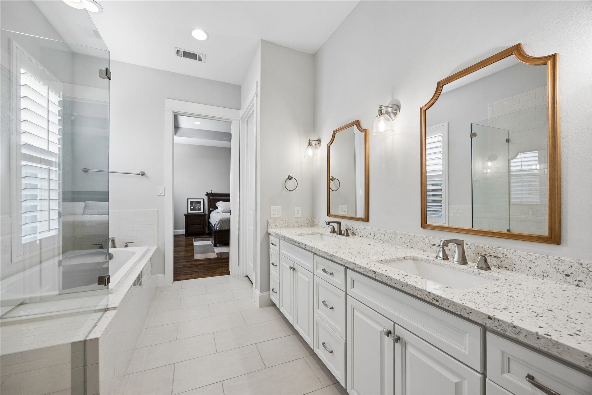 2915 Hicks Street, Houston, TX 77007 Elegant bathroom featuring a dual-sink vanity with granite countertops, a luxurious soaking tub, and a spacious glass-enclosed shower.