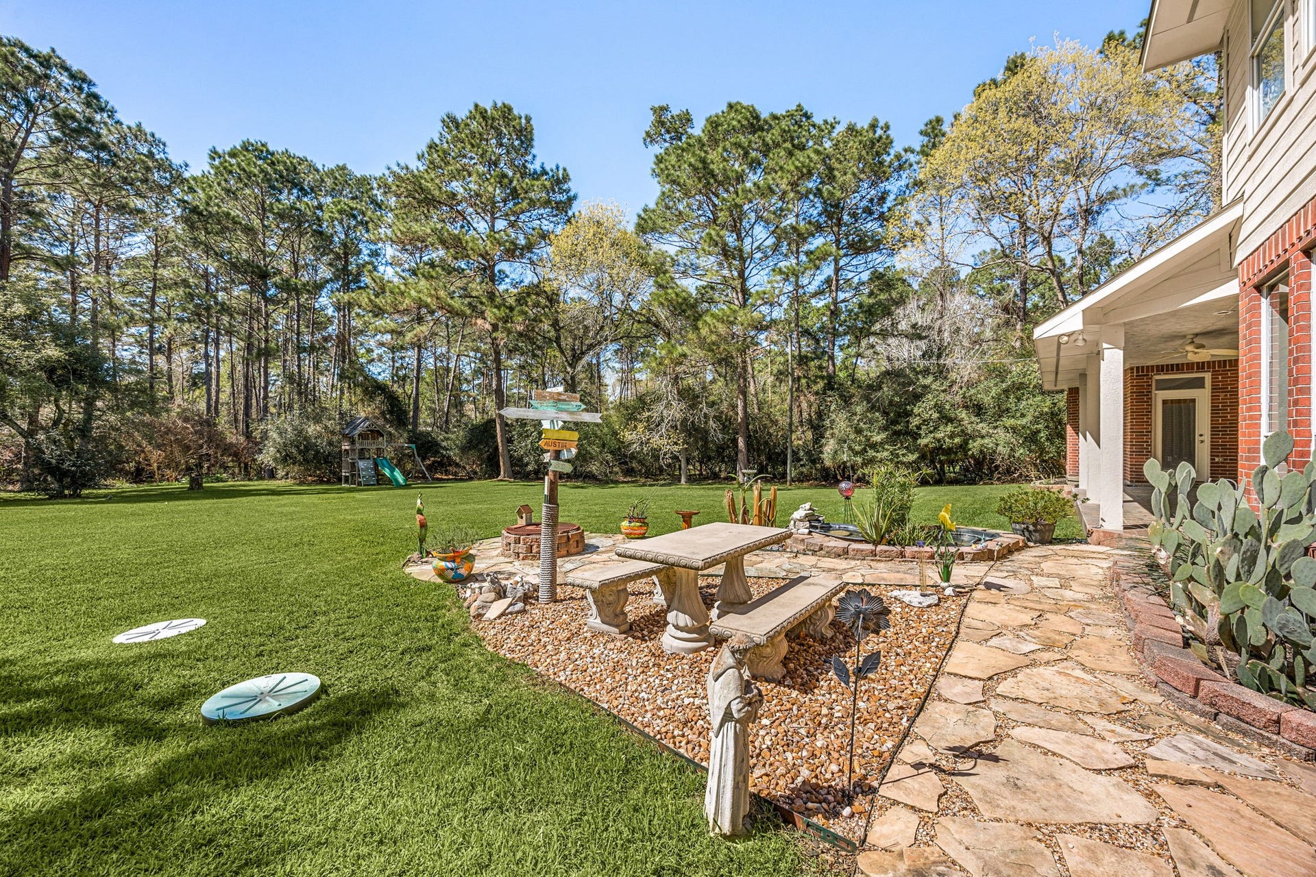 Enjoy the peaceful backyard featuring a patio seating area, landscaped garden space, and plenty of room for outdoor gatherings.