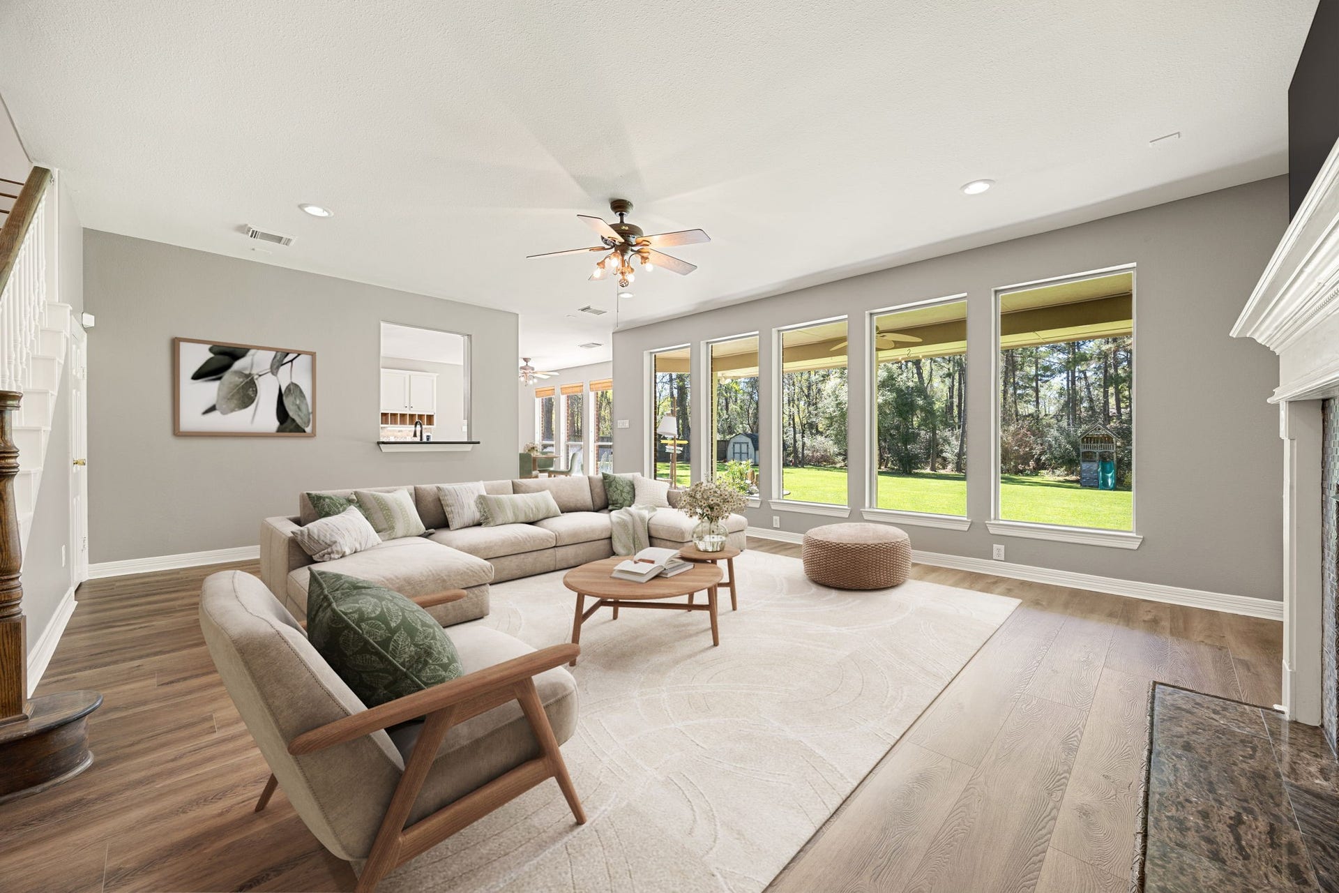 Bright and spacious living area featuring a wall of windows that fills the room with natural light and offers beautiful views of the backyard. The open layout creates the perfect space for both relaxing and entertaining. *virtually staged*