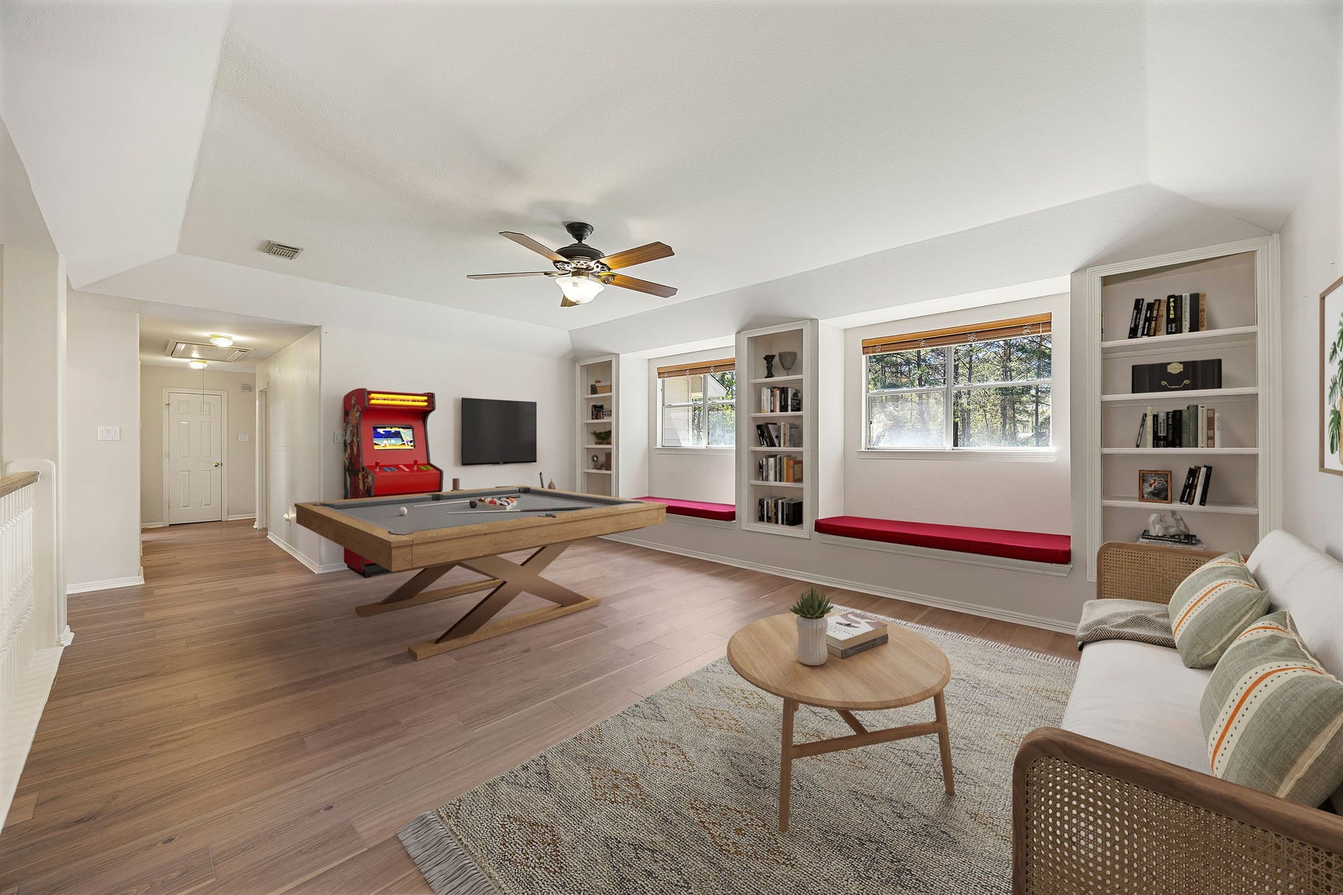 Large upstairs game room with natural light, built-in shelves, and plenty of space for entertaining, relaxing, or creating a media room. *virtually staged*