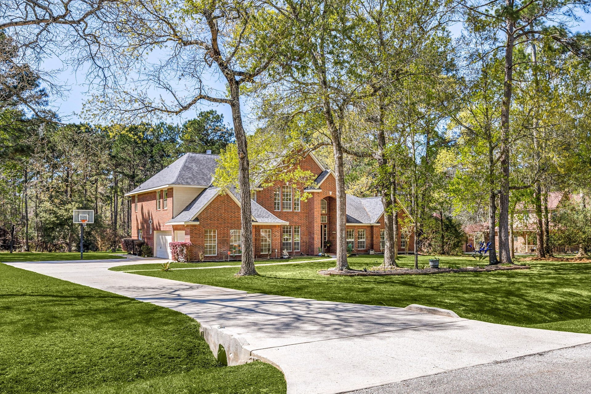 Oversized lot with mature trees, long driveway, and beautiful curb appeal. 14419 Timbergreen Drive offers space, privacy, and a peaceful setting.