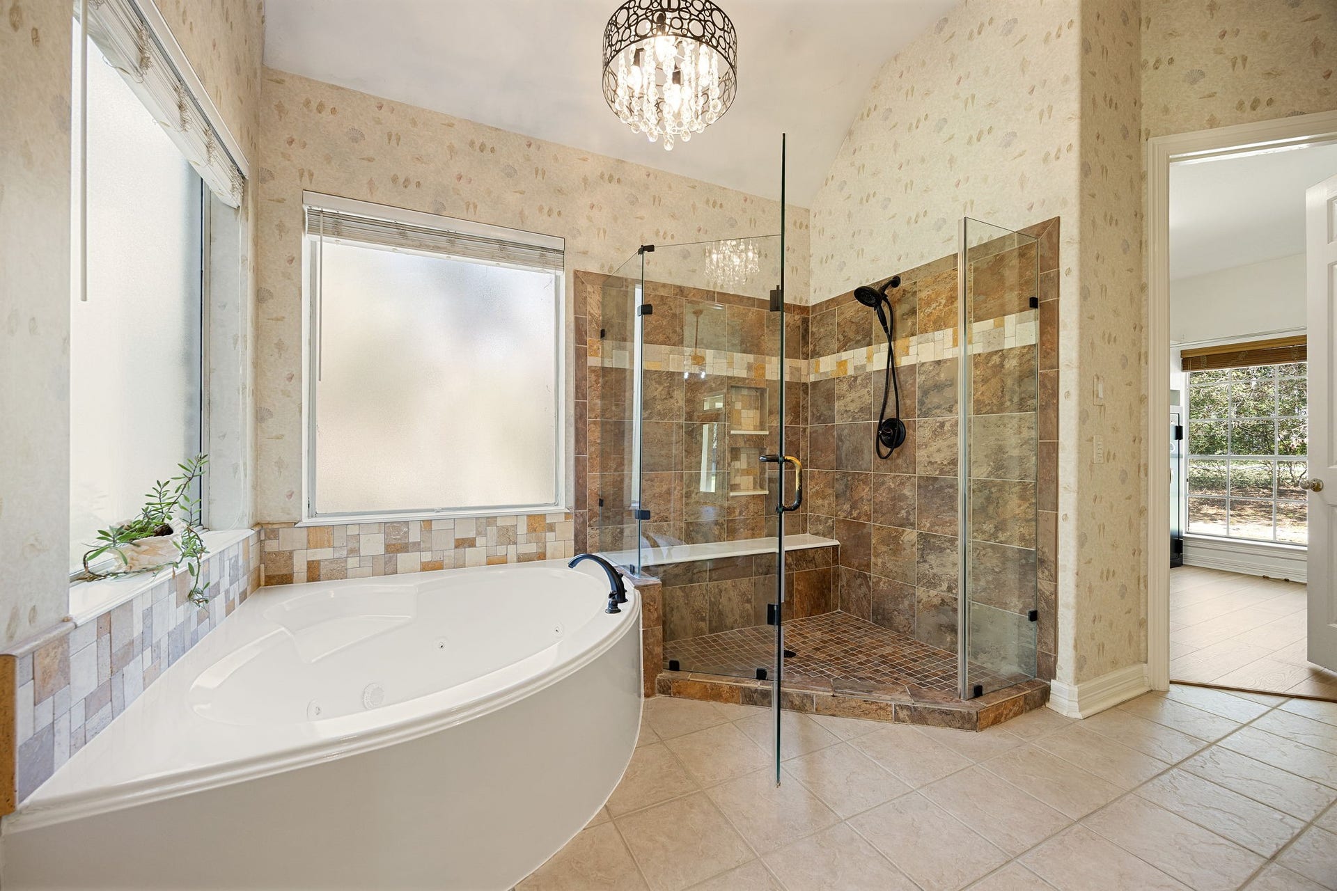 Enjoy this large primary bathroom with a soaking tub, walk-in shower, and elegant tile finishes. Designed with space and comfort in mind, this bathroom feels like your own private retreat.