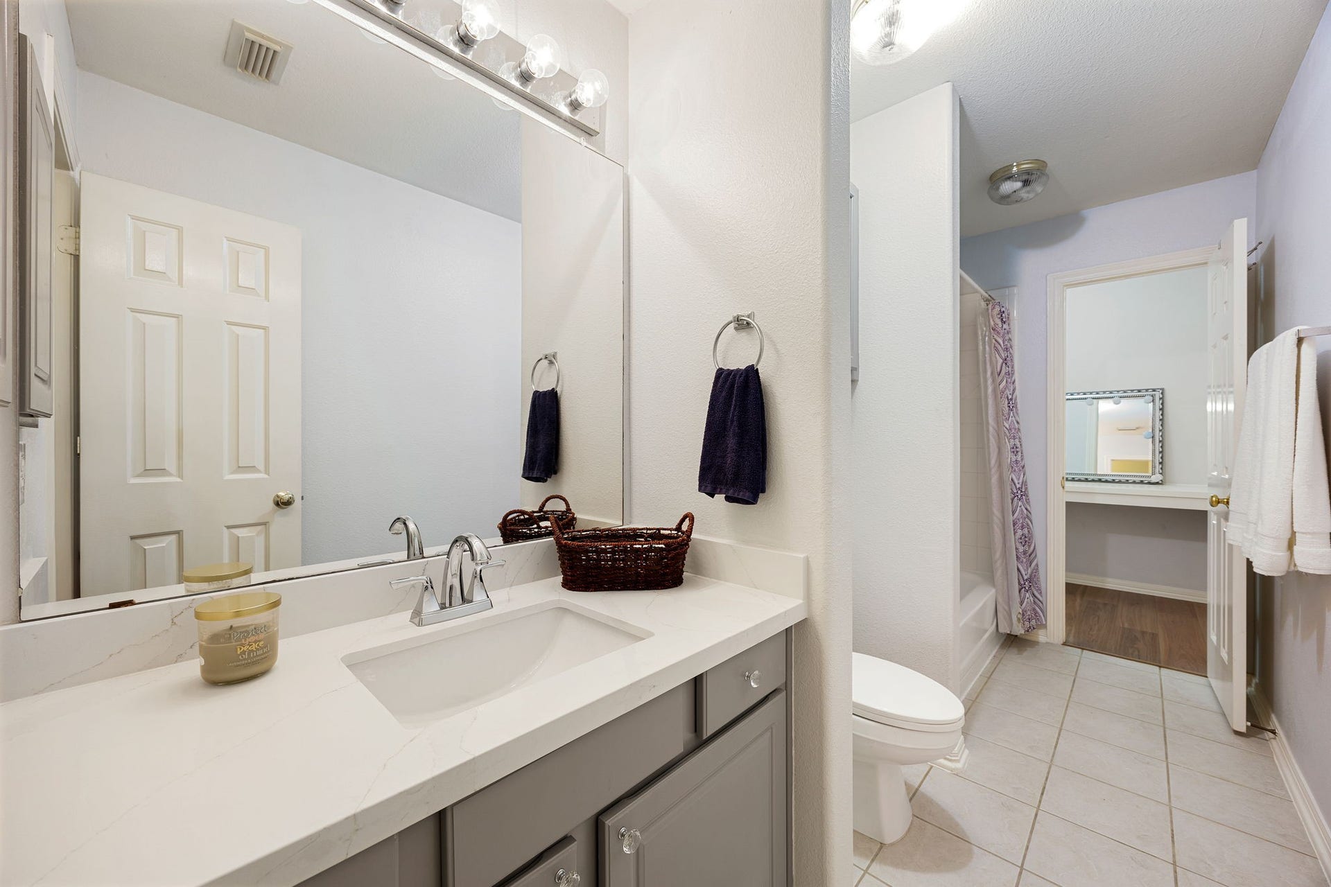 Full bathroom with single vanity, tub/shower combo, and functional layout. Conveniently located to serve secondary bedrooms and guests.