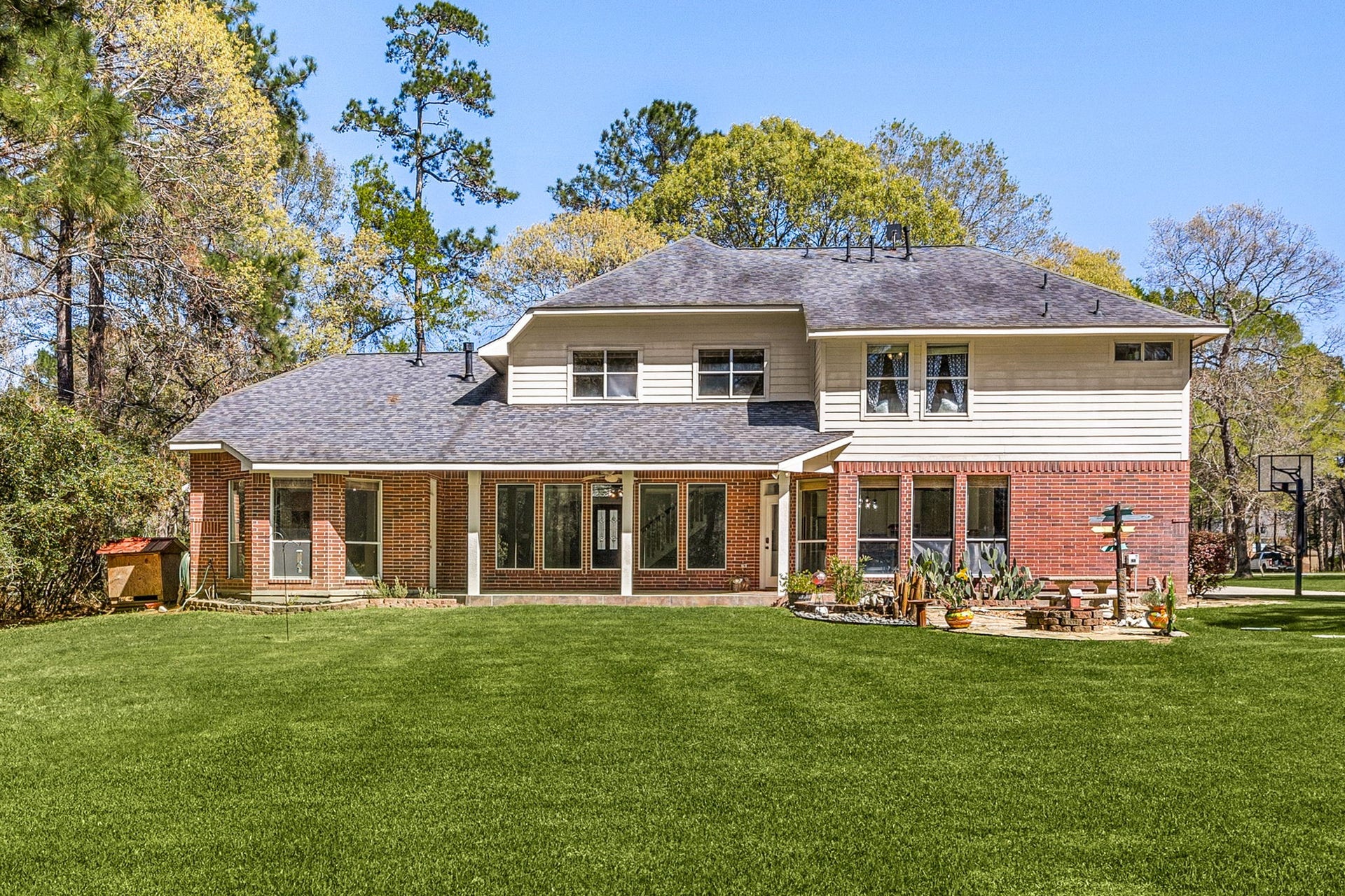 Enjoy the expansive backyard with mature trees, covered patio, and plenty of space for outdoor living, entertaining, or play.