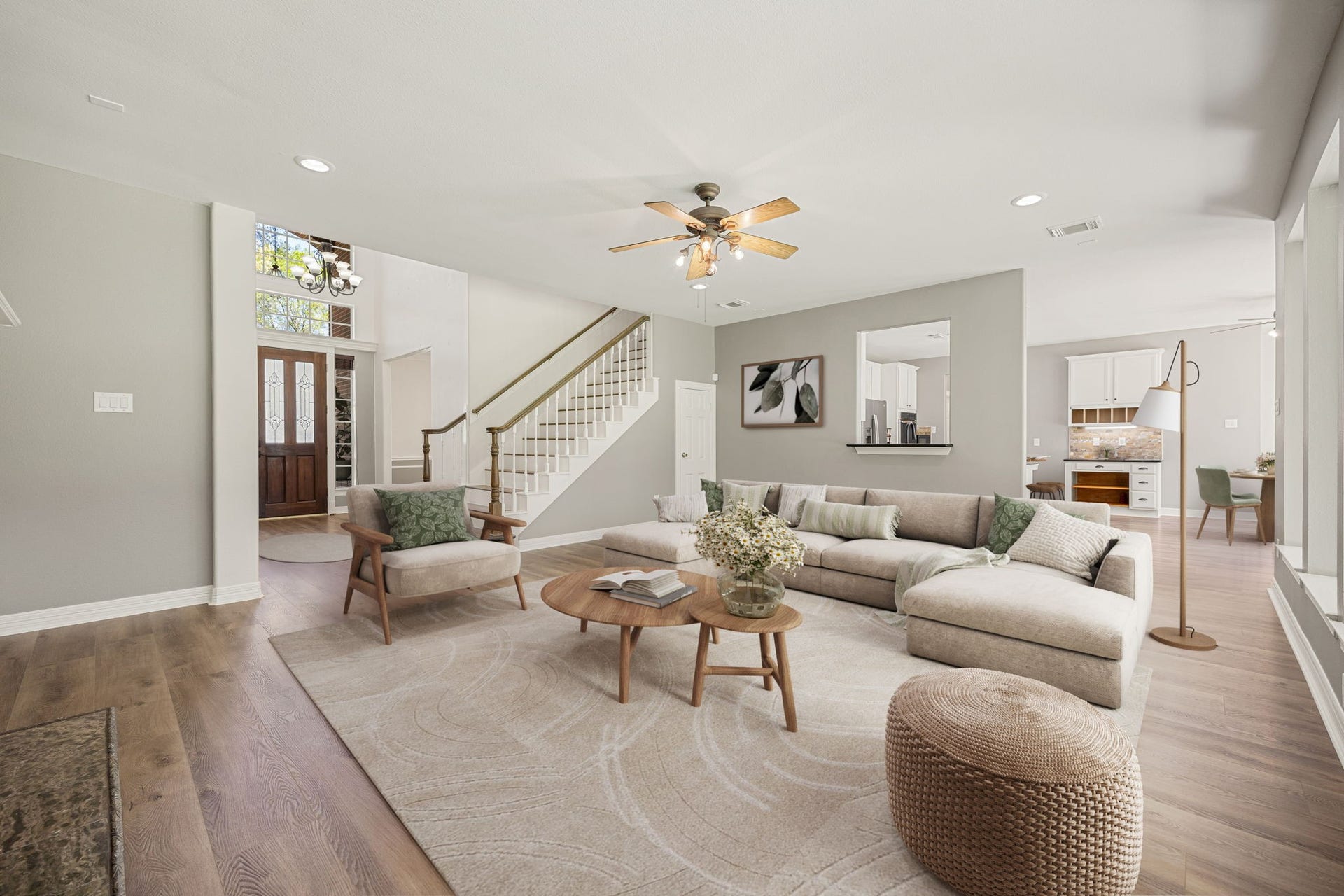 This bright and spacious living area offers an open-concept design with views to the grand entry, staircase, and kitchen, creating a perfect flow throughout the home. Ideal for gatherings, entertaining, and comfortable daily living. *virtually staged*