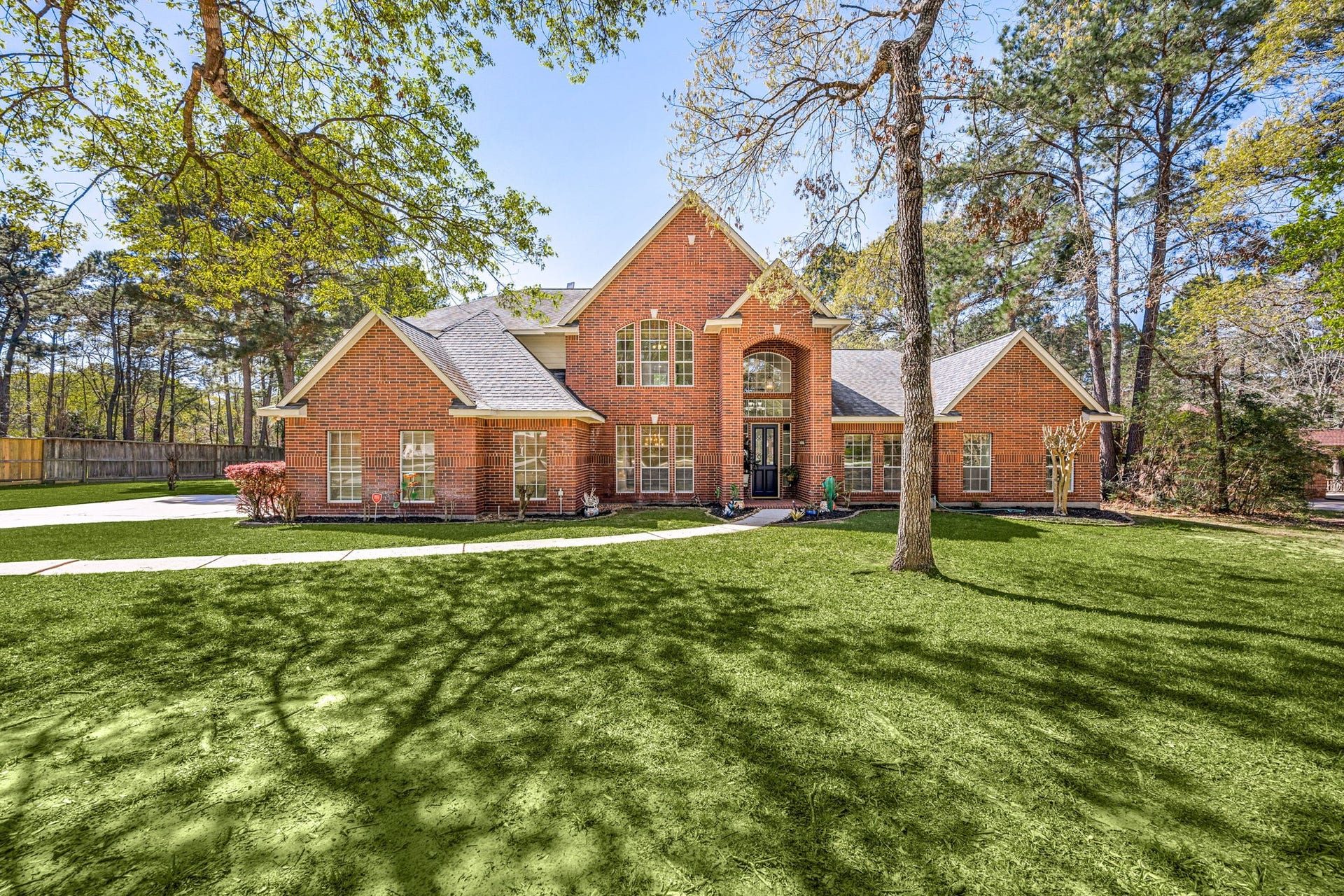 Beautiful two-story brick home situated on a spacious, tree-filled lot featuring mature landscaping, a wide front yard, and a grand front elevation. The impressive entry and timeless architecture create a warm and elegant first impression with plenty of space to enjoy both indoors and outdoors.