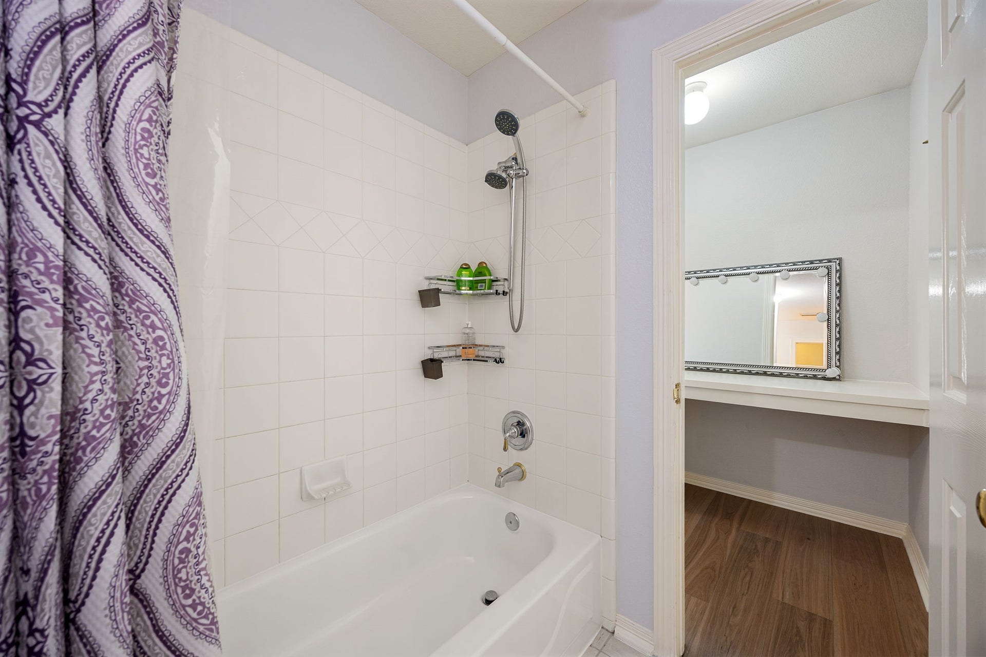 Clean and functional tub/shower combo with tile surround, ideal for family or guests.