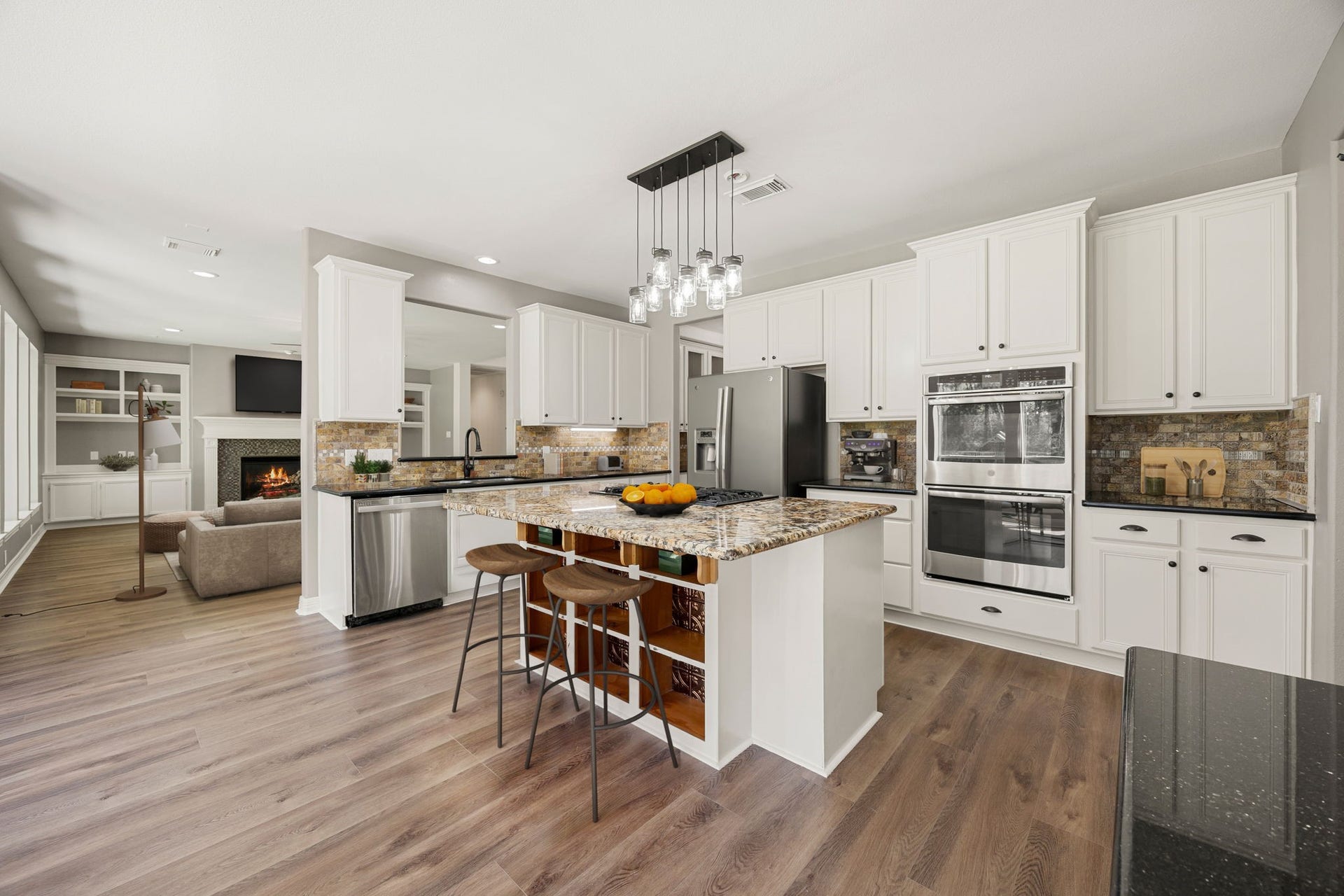 Beautiful kitchen featuring a large center island, granite countertops, stainless steel appliances, and plenty of cabinet space. The open layout flows seamlessly into the living area, making it perfect for both everyday living and entertaining. *virtually staged*