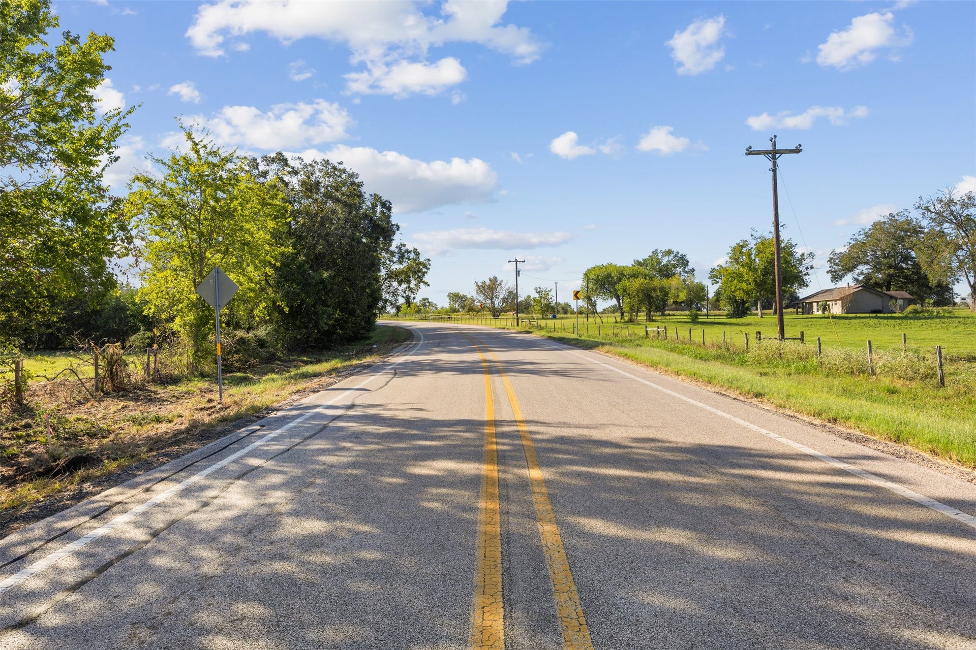 Traveling south along FM 1887, with the property situated on the left, showcasing its paved road frontage and the surrounding rural landscape of Waller County.