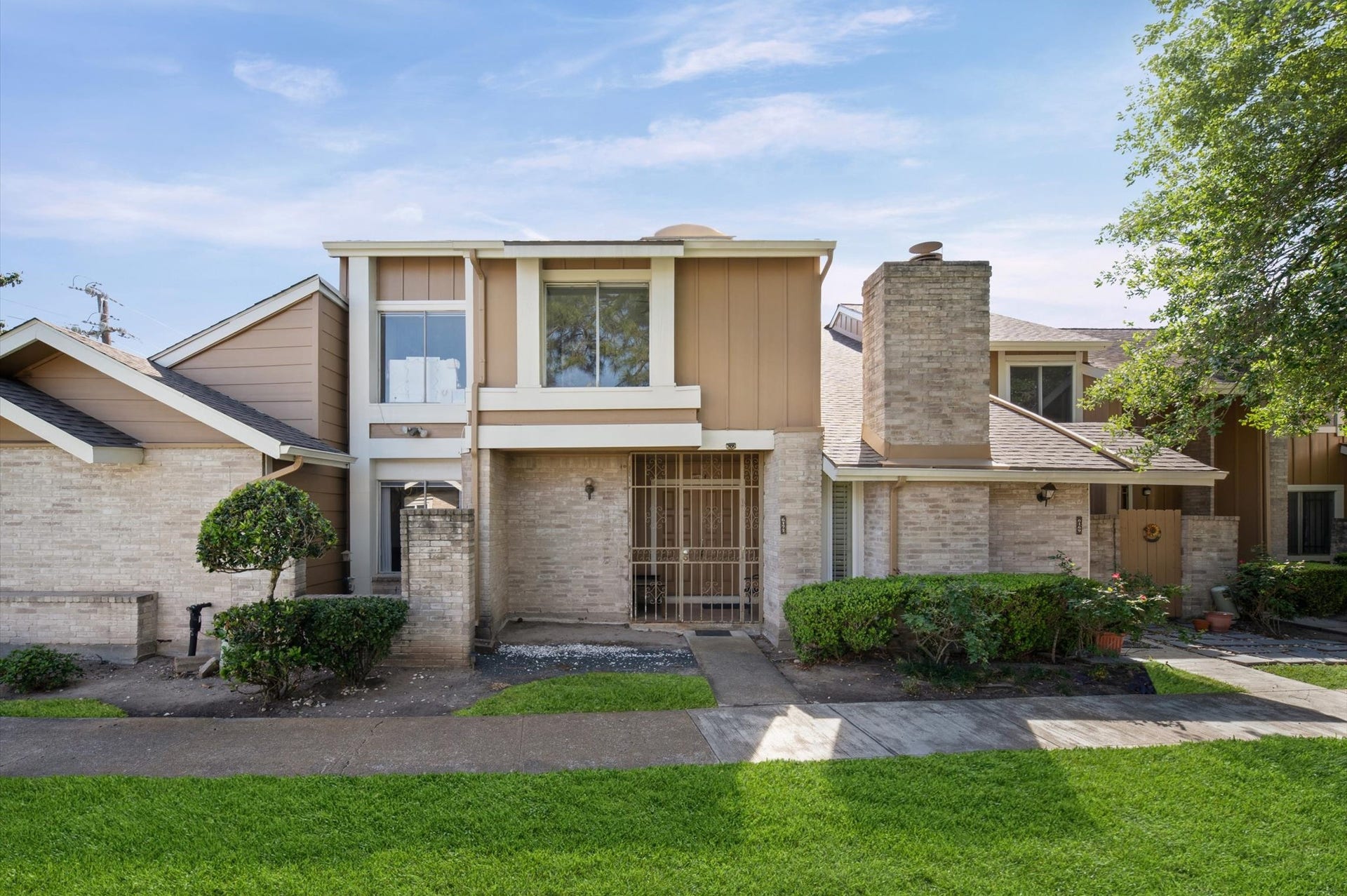 6171 Dryad Drive, Houston, TX 77035 Charming two-story townhouse with classic brick exterior, private entry, and attached garage.
