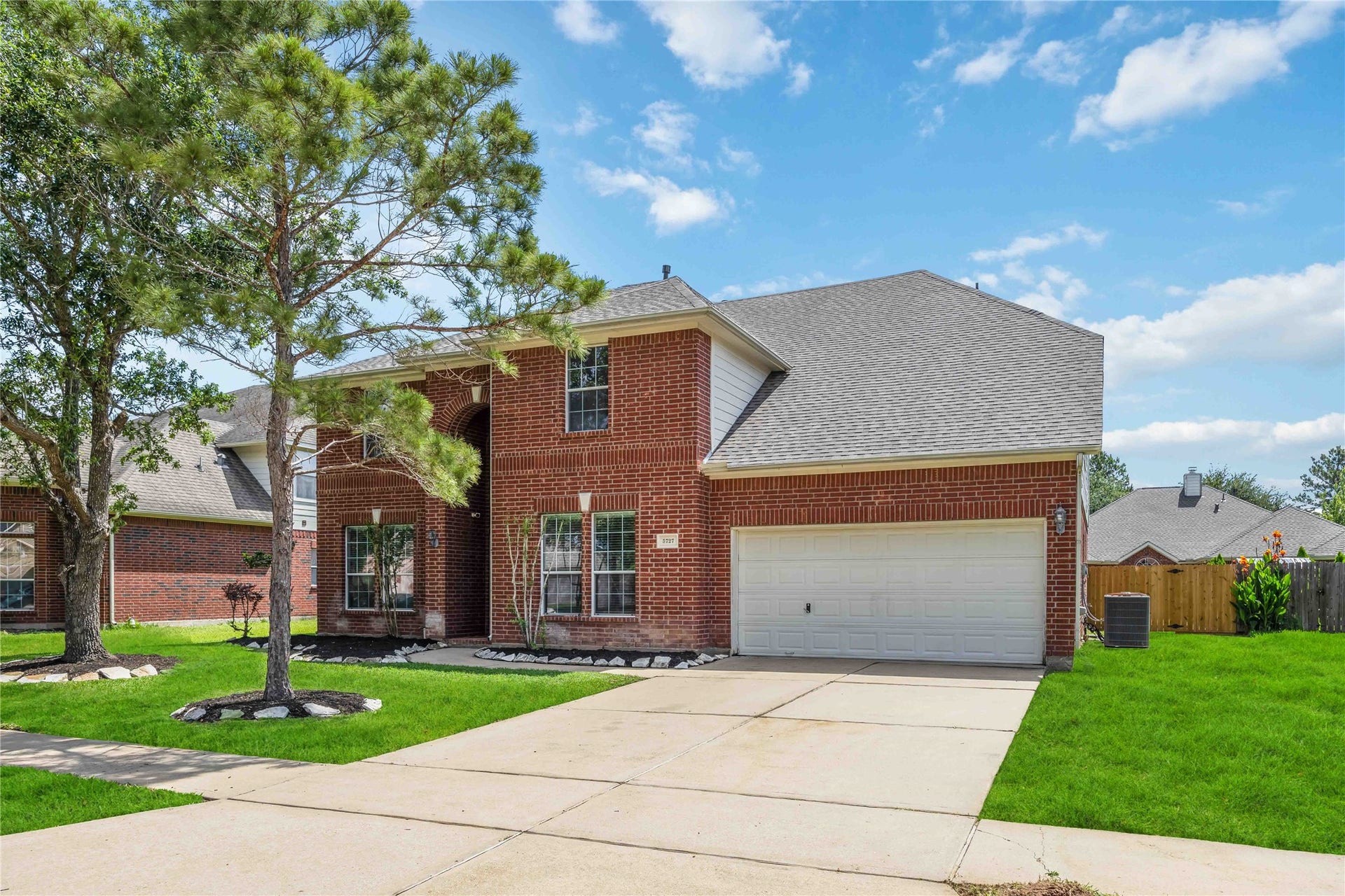 5727 Candlecreek Drive, Richmond, TX 77469 The full exterior showcases a timeless brick design and an impressive two-story presence. A wide driveway creates an easy and welcoming approach home.