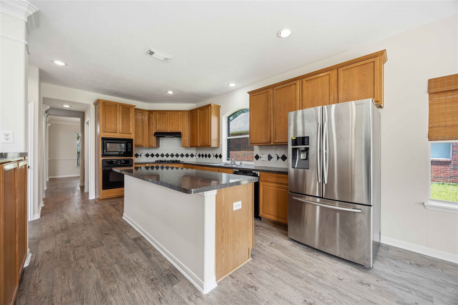 5727 Candlecreek Drive, Richmond, TX 77469 The center island creates an easy gathering spot for meal prep, conversation or a quick bite. There is room to cook without feeling closed off from the rest of the home.
