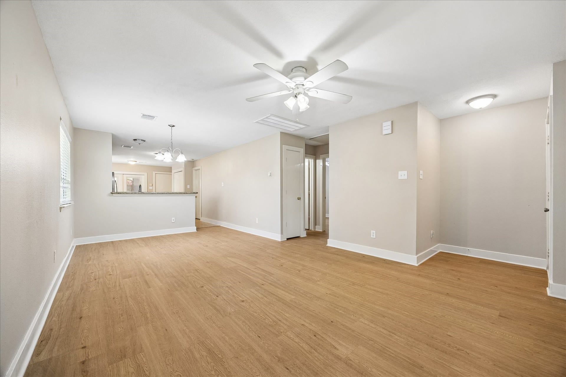 10819 Cobblecreek Way, Missouri City, TX 77459 The open living and dining area gives you plenty of room to relax, gather and make the space your own, with fresh neutral paint, soft natural light and newly installed (July 2026), durable wood-look laminate flooring. and an easy flow into the kitchen keeping the layout comfortable and connected.