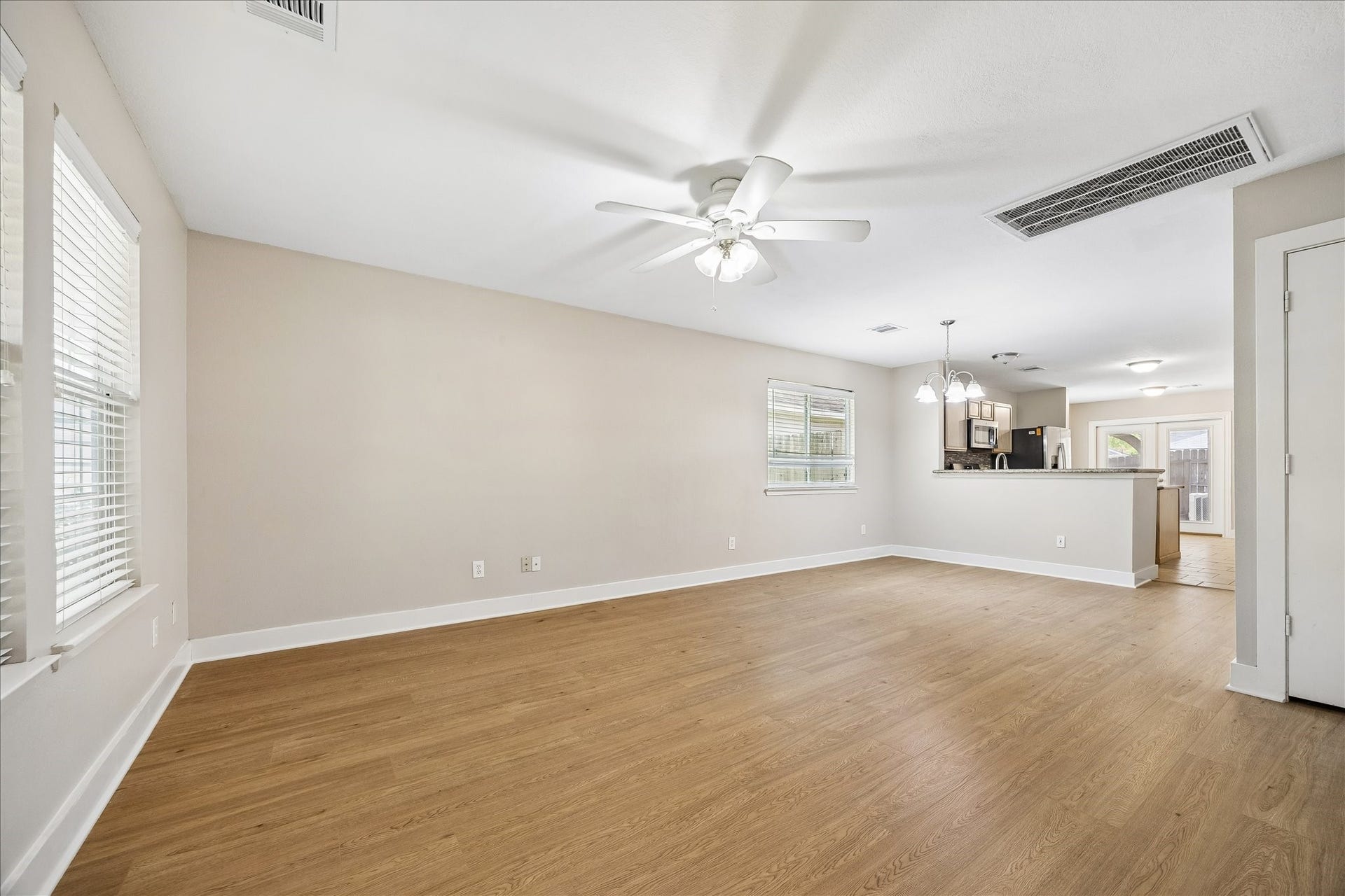 10819 Cobblecreek Way, Missouri City, TX 77459 Step inside to discover a bright, open combined living and dining area with fresh neutral paint and newly installed (July 2026), durable wood-look laminate flooring throughout, except in the kitchen and bathrooms. The flexible layout feels easy and welcoming, with plenty of room for everyday living, dining and gathering.