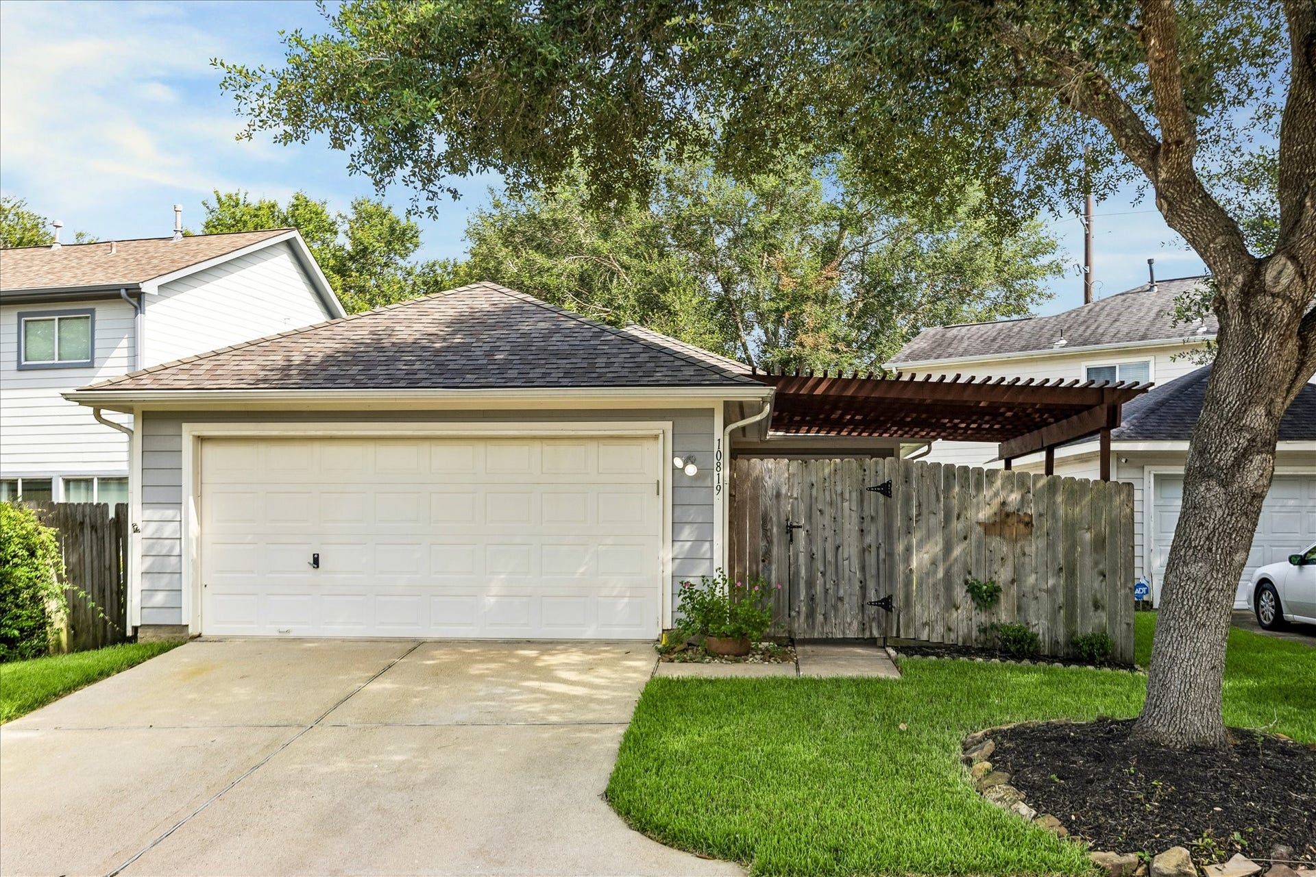 10819 Cobblecreek Way, Missouri City, TX 77459 The 2-car garage and driveway offer convenient off-street parking with the fenced patio area tucked discreetly behind the fence.