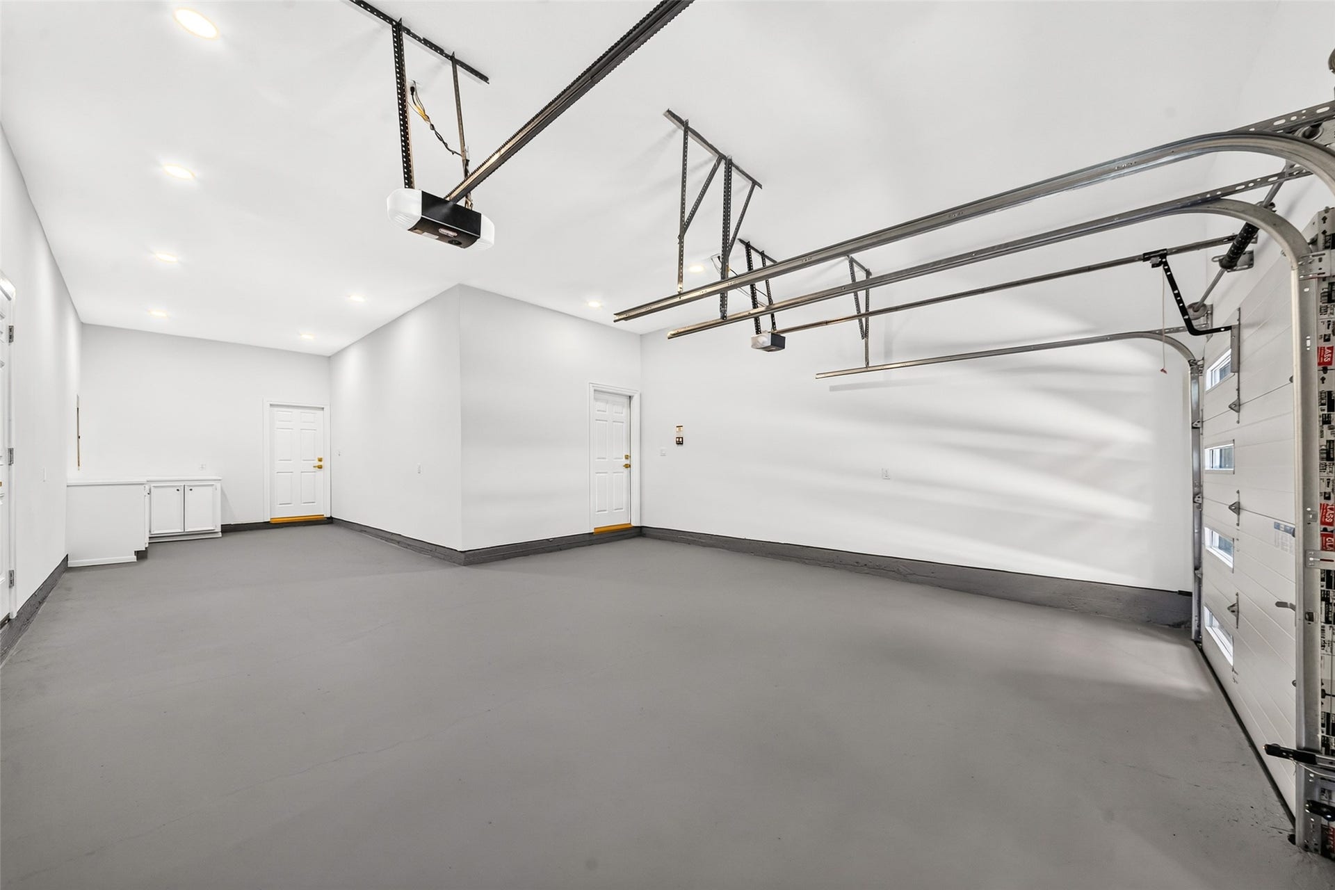 46 Pebble Cove Drive, The Woodlands, TX 77381 Spacious and sleek, this three-car garage offers ample room for your vehicles and extra storage needs, combining functionality with style.