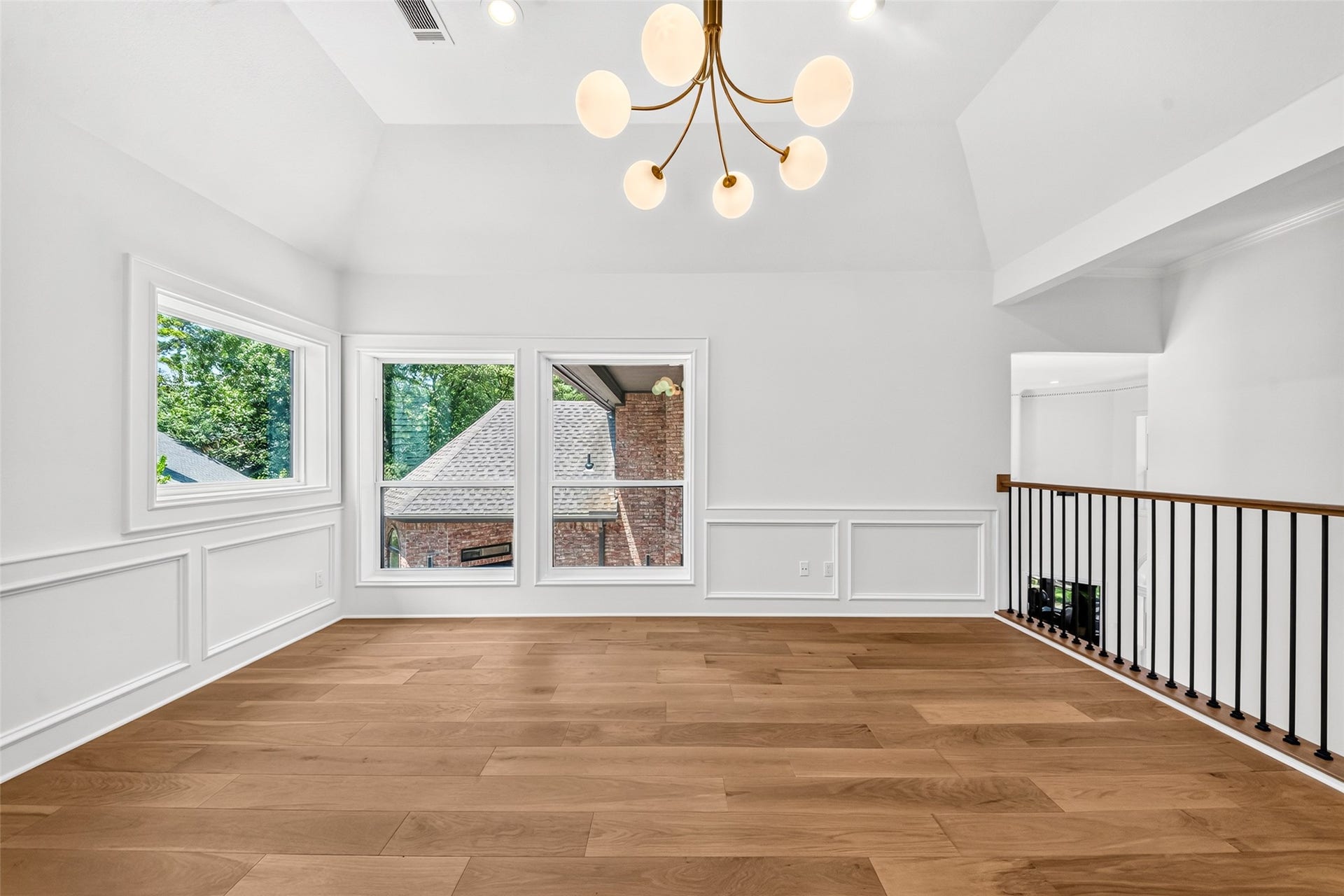 46 Pebble Cove Drive, The Woodlands, TX 77381 Elevate your leisure time in this bright second-story game room, featuring stylish hardwood floors and abundant natural light.