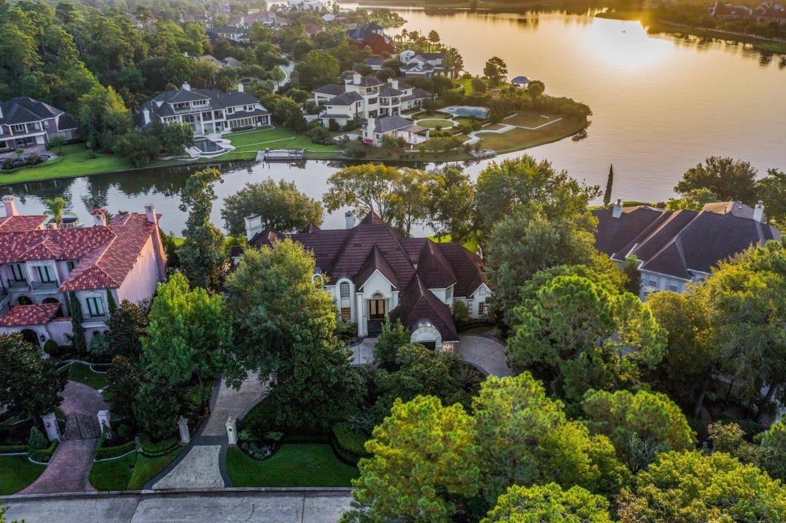 35 W Isle Place, The Woodlands, TX 77381 Aerial view highlighting the estate's prime waterfront location and surrounding neighborhood.